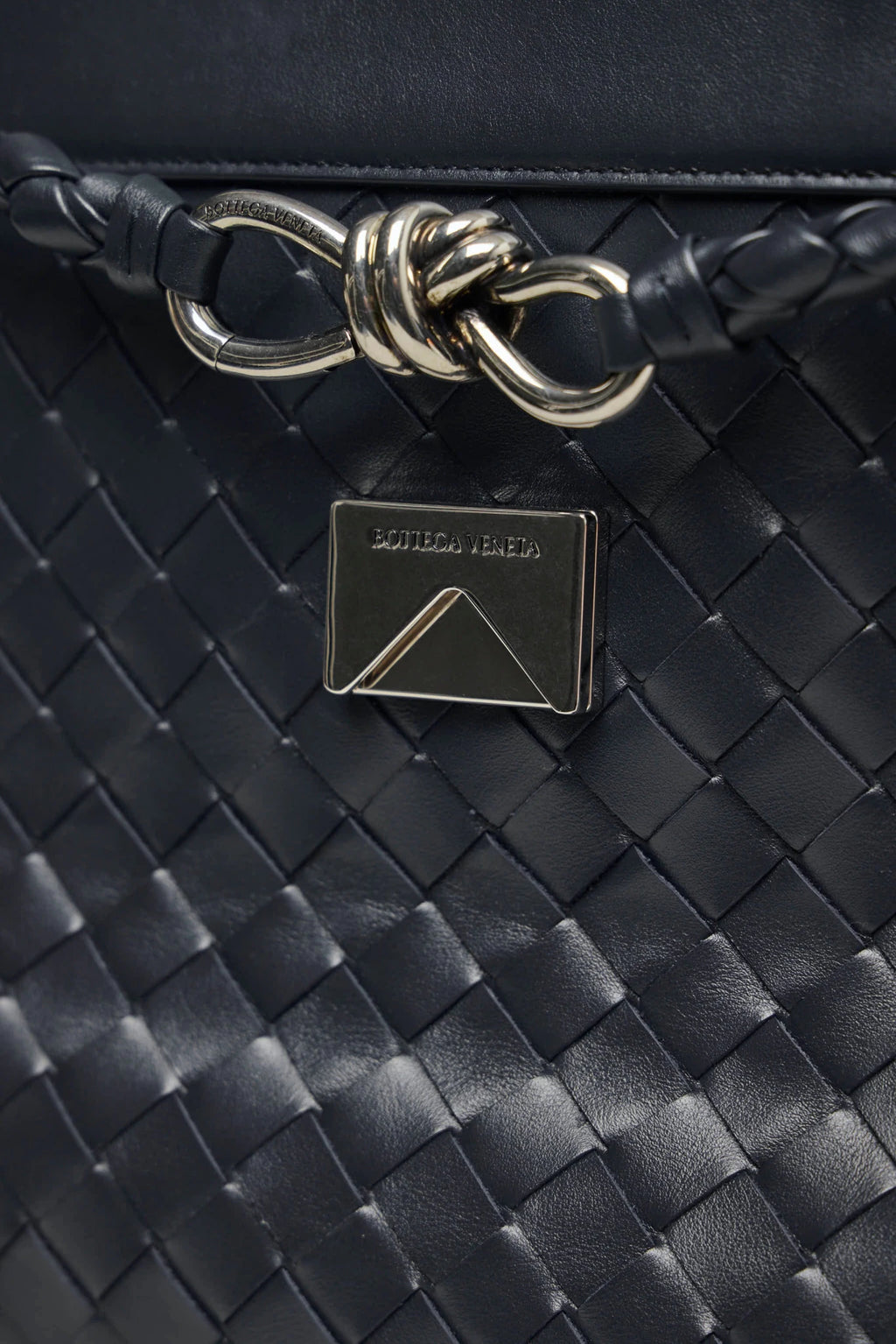 Bottega Veneta leather clutch styled as crossbody bag