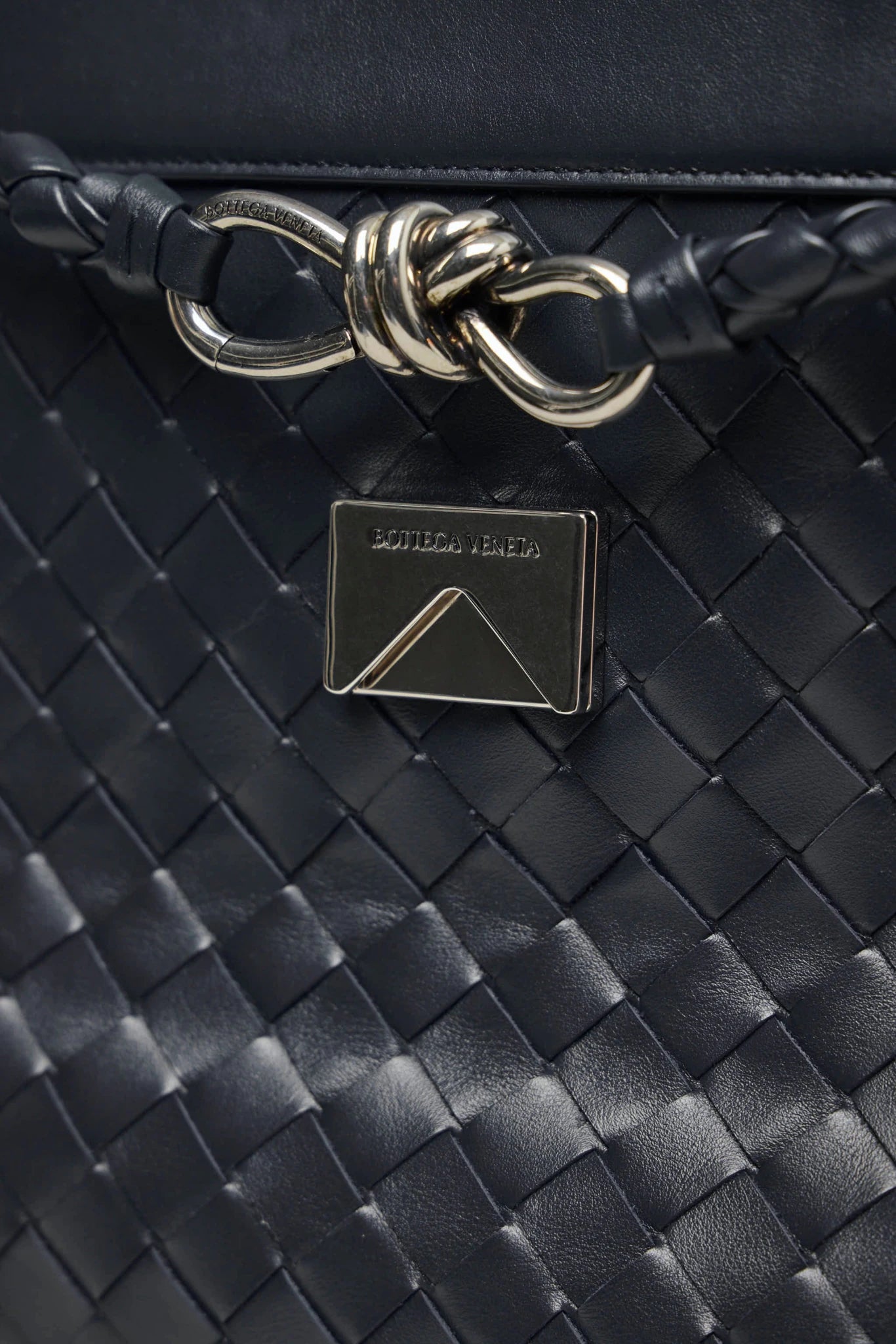 Bottega Veneta leather clutch styled as crossbody bag