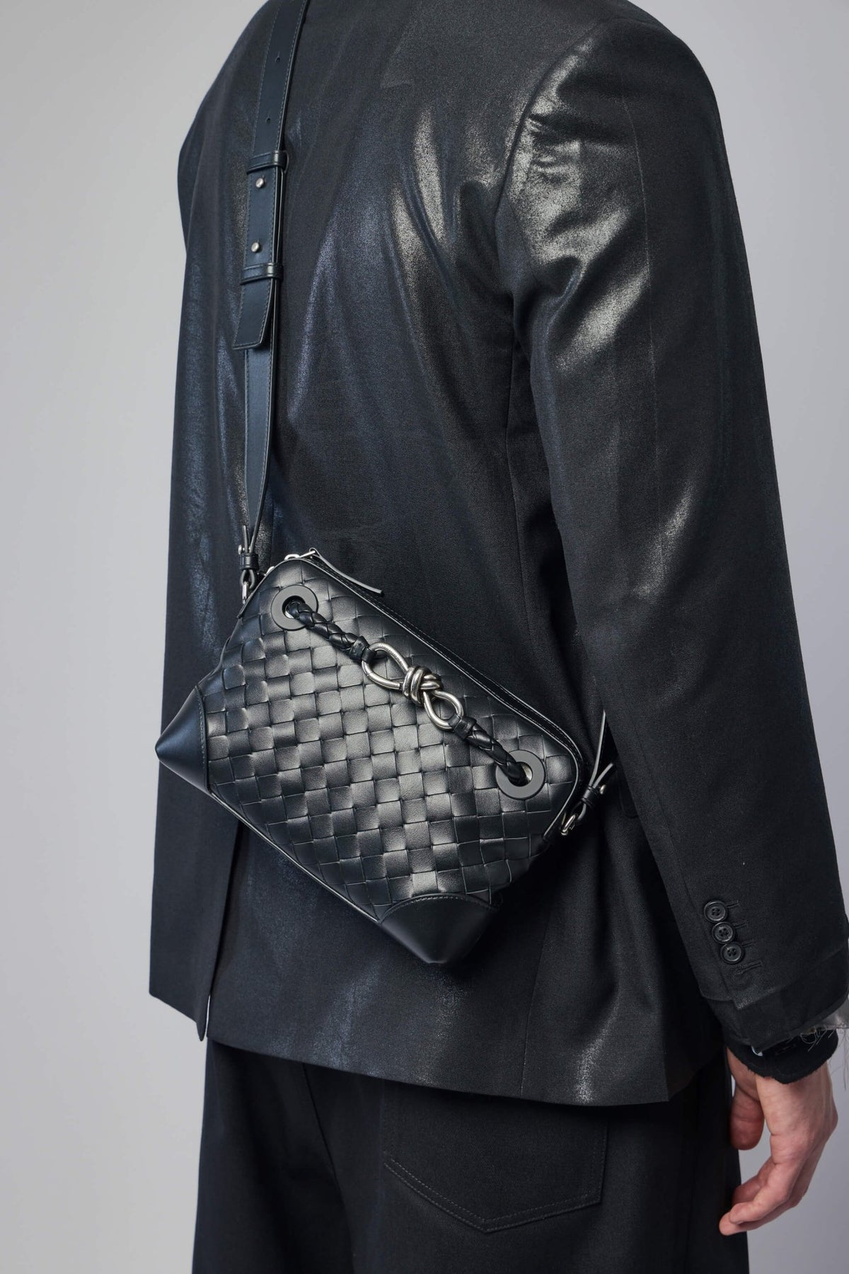Model wearing Bottega Veneta crossbody bag styled with contemporary menswear