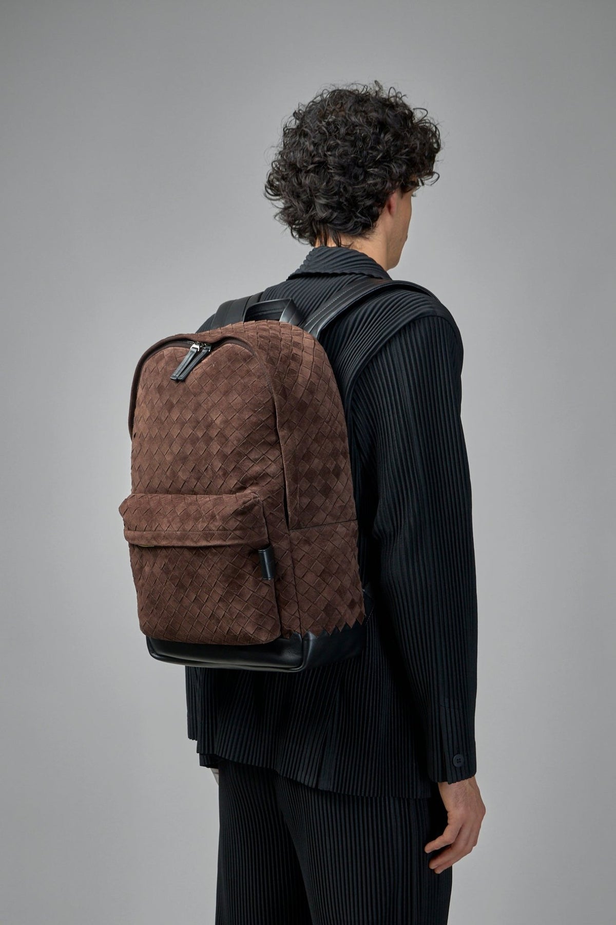 Top handle and zipper closure detail on Intreccio backpack