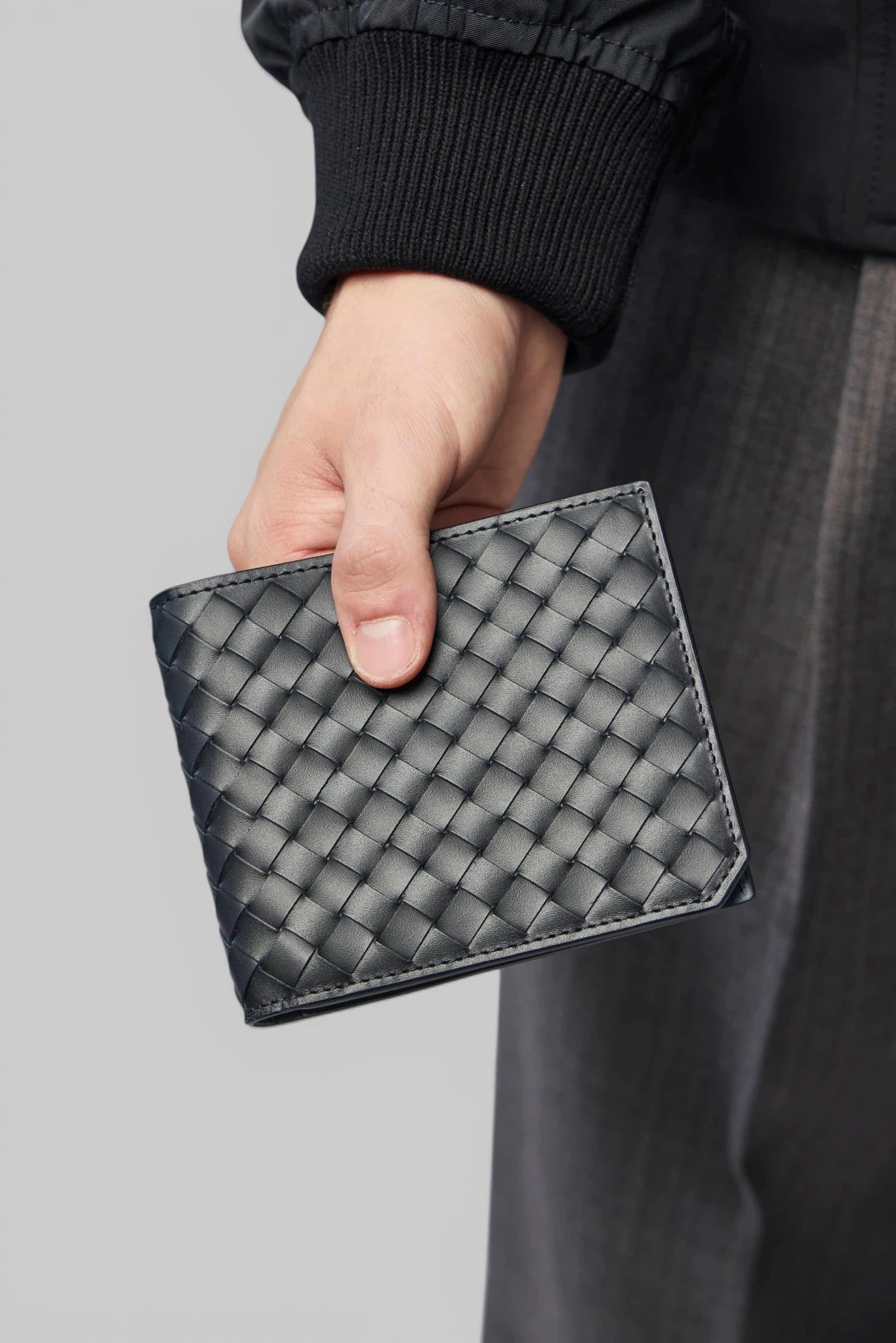 Close-up of woven leather texture on Bottega Veneta wallet