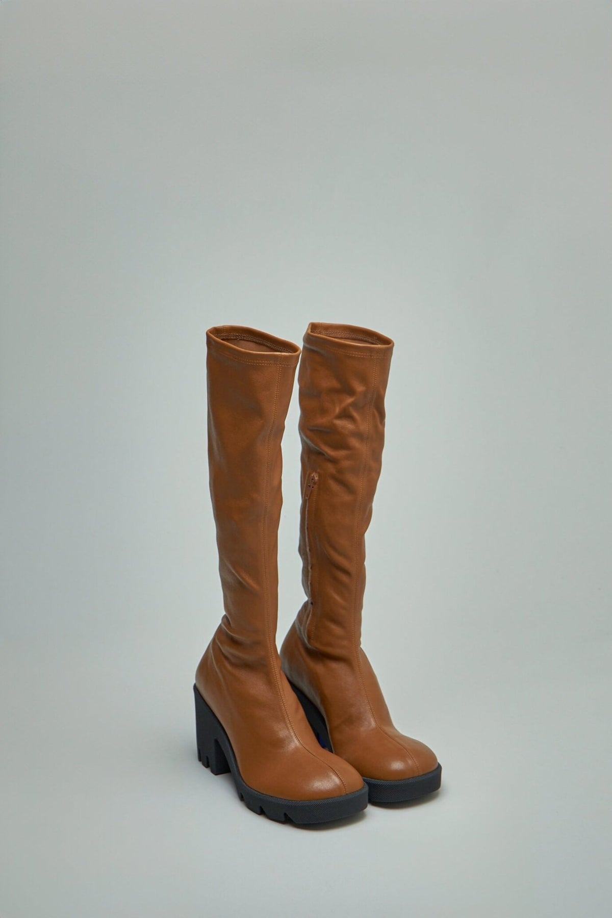 Close-up of Burberry leather stride boots showing signature check insole pattern