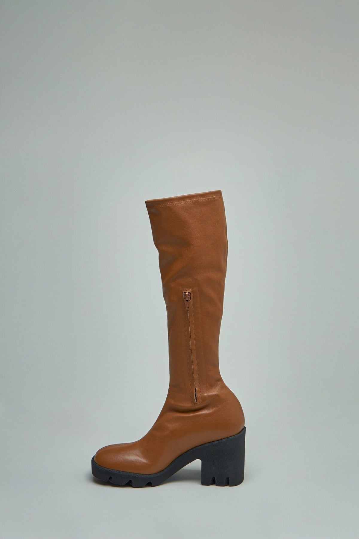 Side view of Burberry block heel boots with rounded toe design