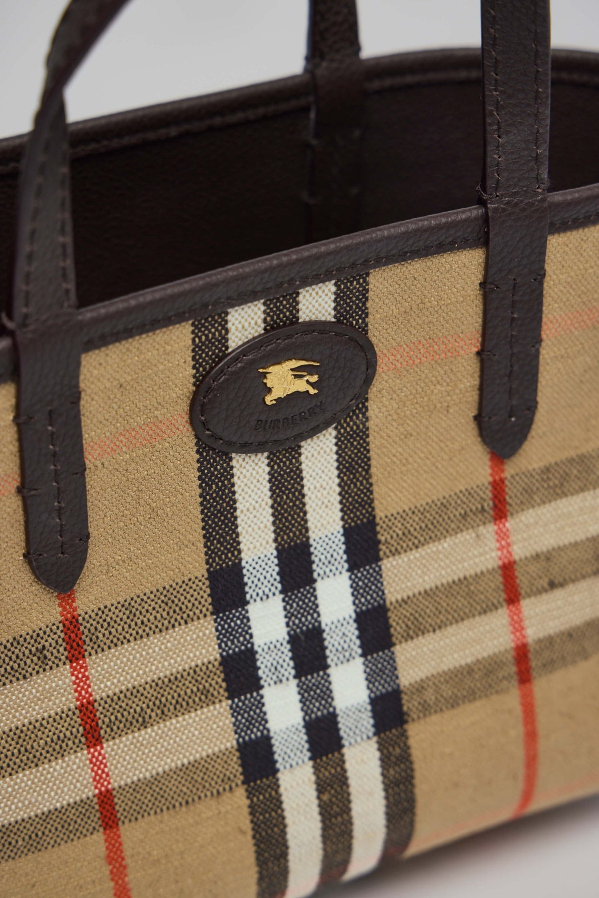 Burberry bag hardware detail with gold-tone metallic accents