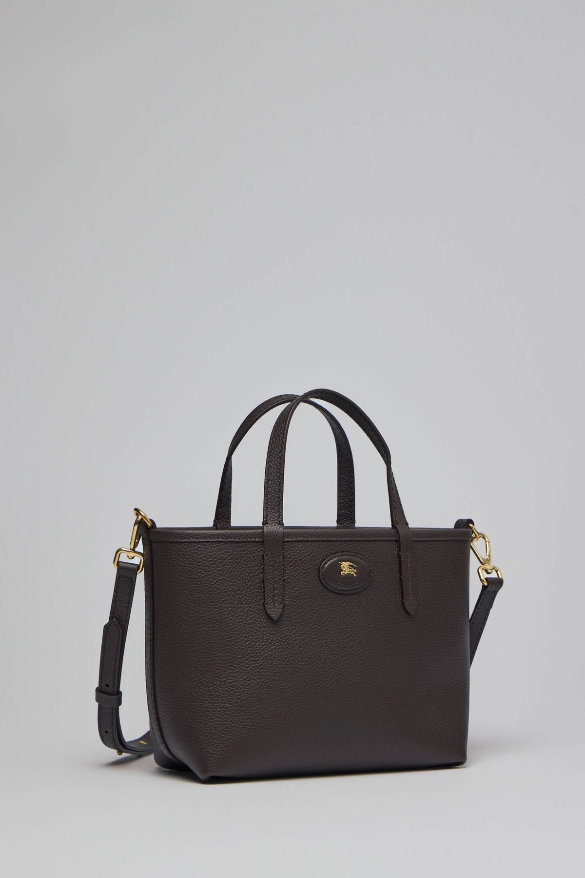 Model carrying Burberry crossbody bag with shoulder strap attached
