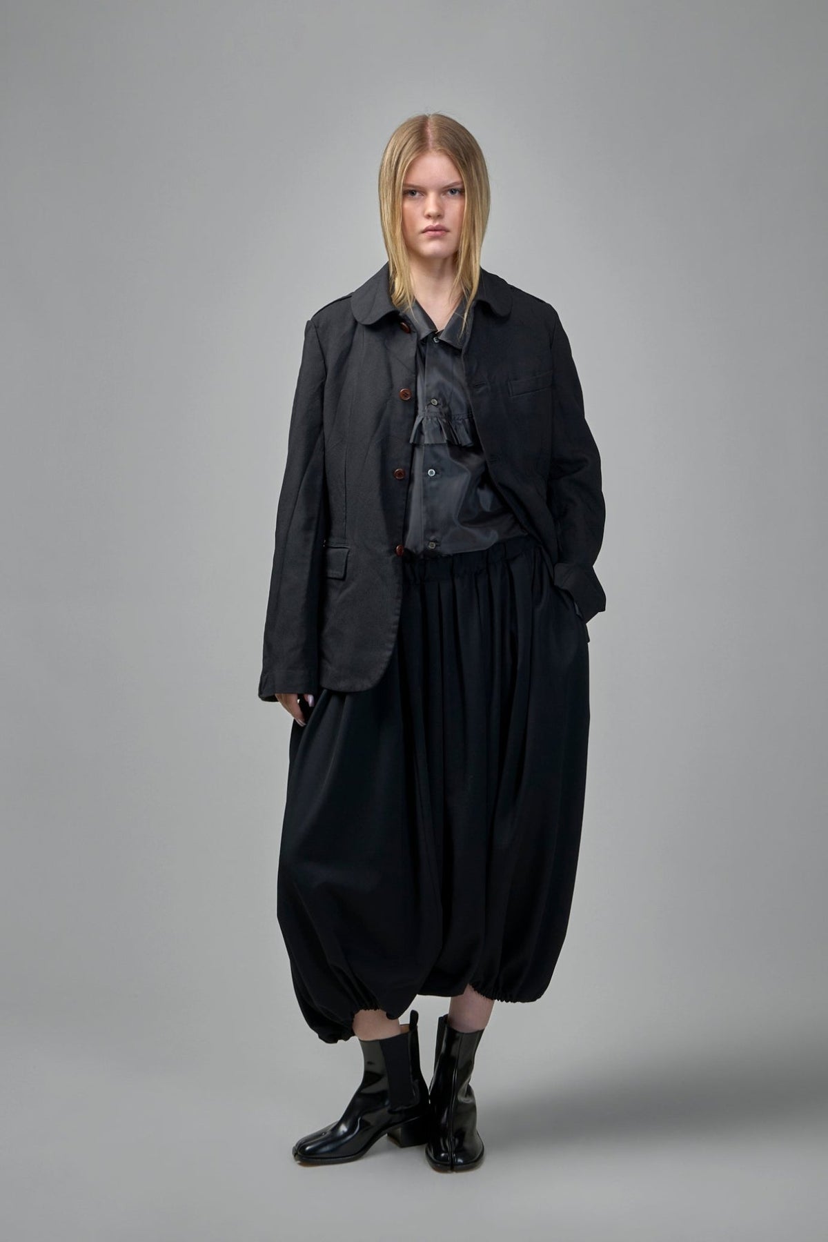 Side profile showing relaxed fit and tailored seams of unisex jacket