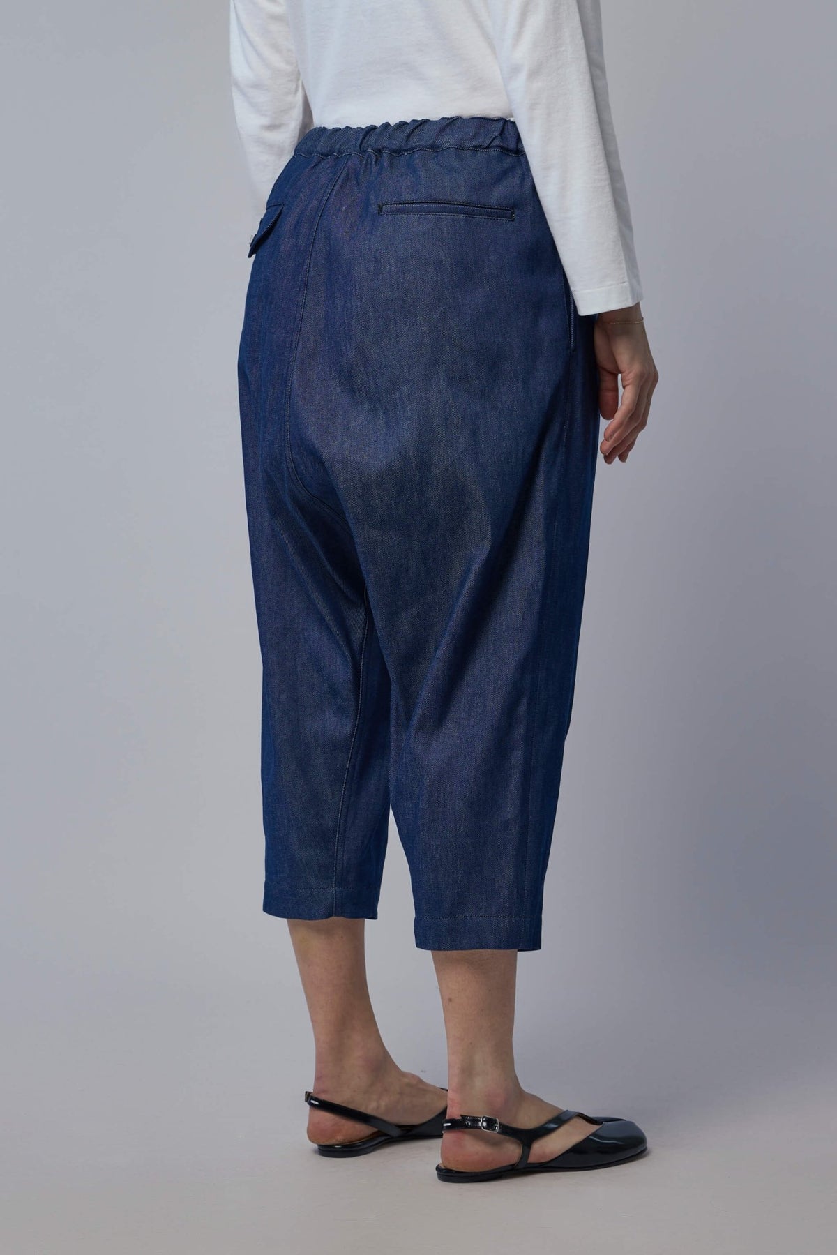 Side profile displaying drop-crotch style and comfortable fit of unisex pants