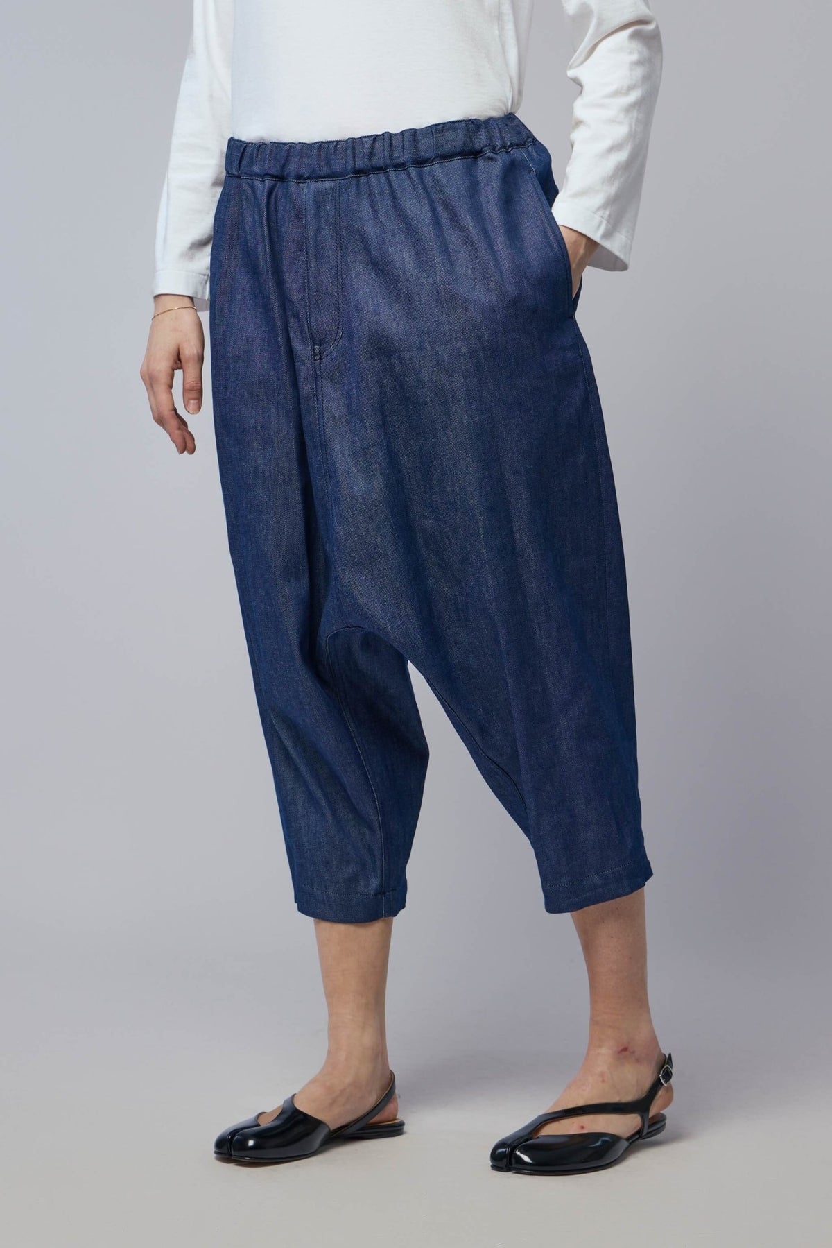 Full-length view showing ankle-length cut and relaxed silhouette of cargo pants