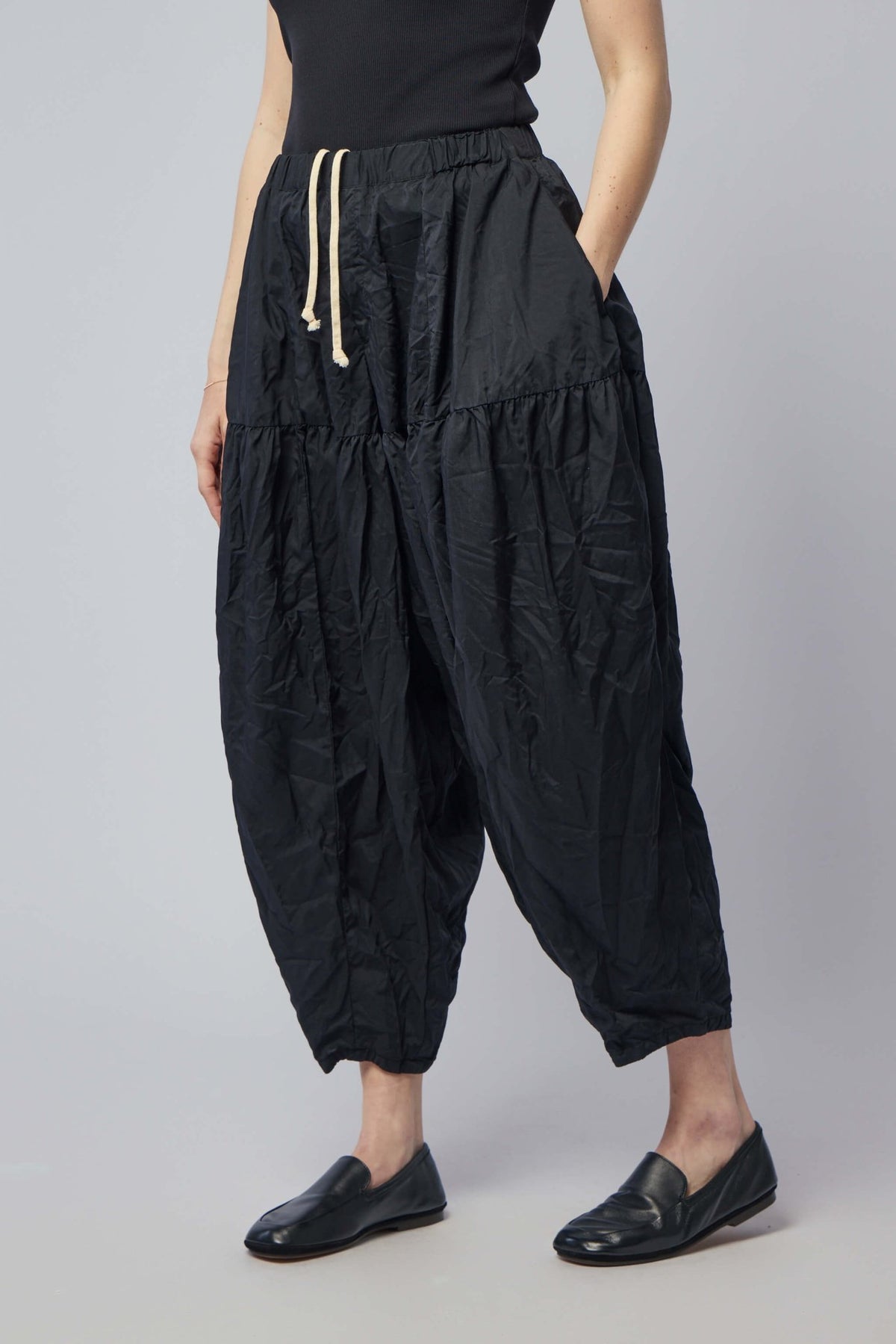 Model wearing Comme des Garçons BLACK unisex cargo pants in size S
