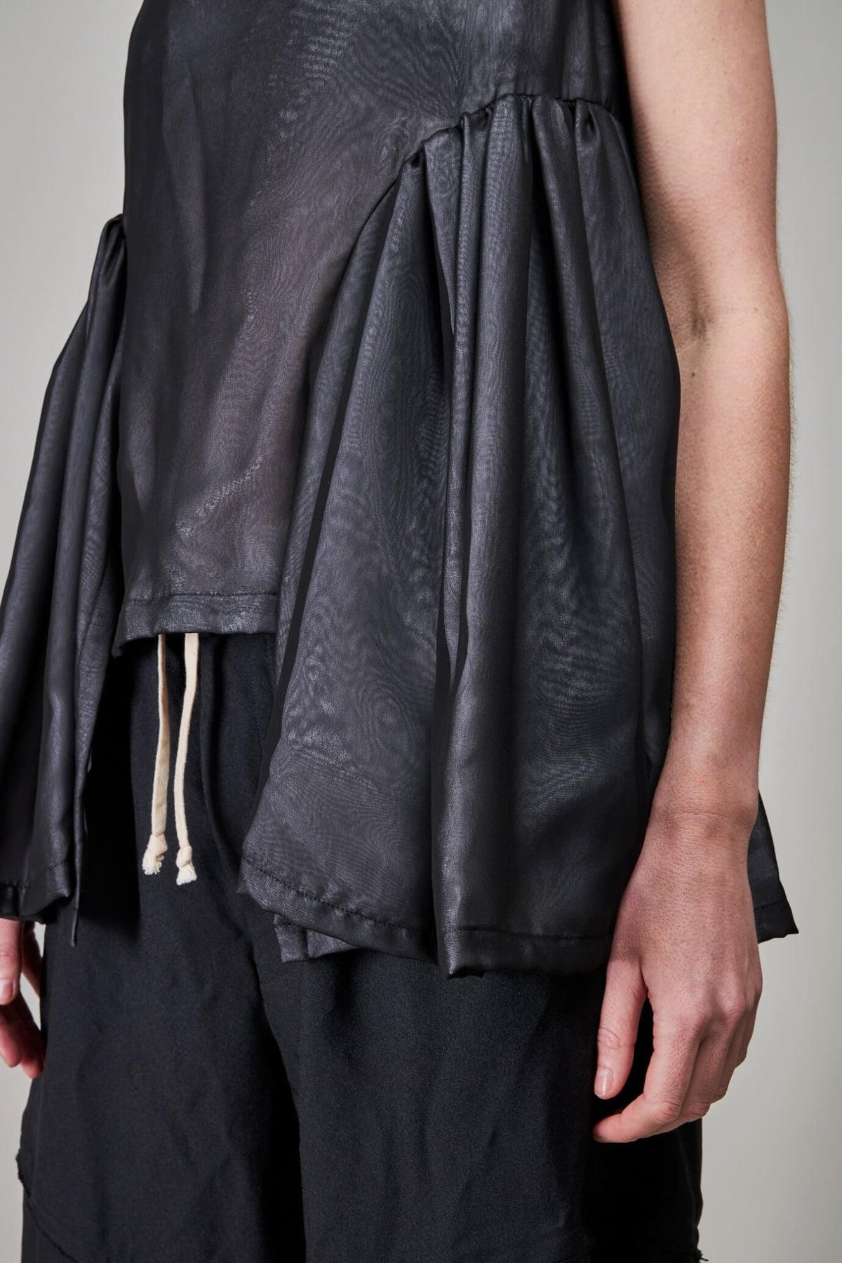 Back view of sleeveless black blouse showing clean construction