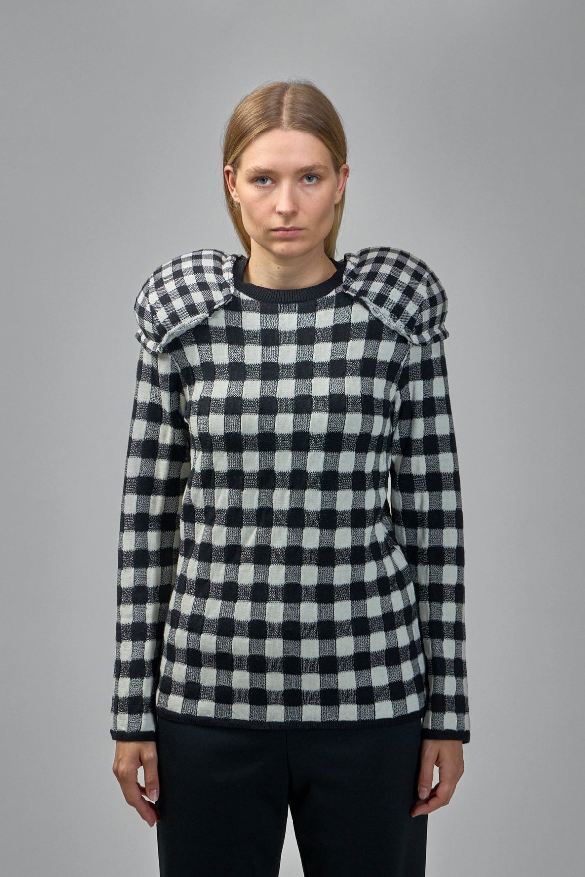 Close-up of ribbed crew neckline and knit texture on Comme des Garçons sweater