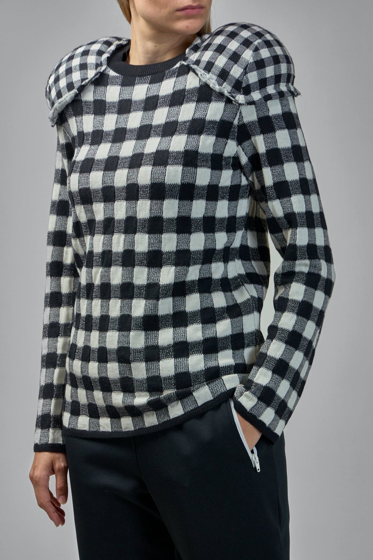 Detail of distinctive padded shoulder construction on Comme des Garçons knitwear