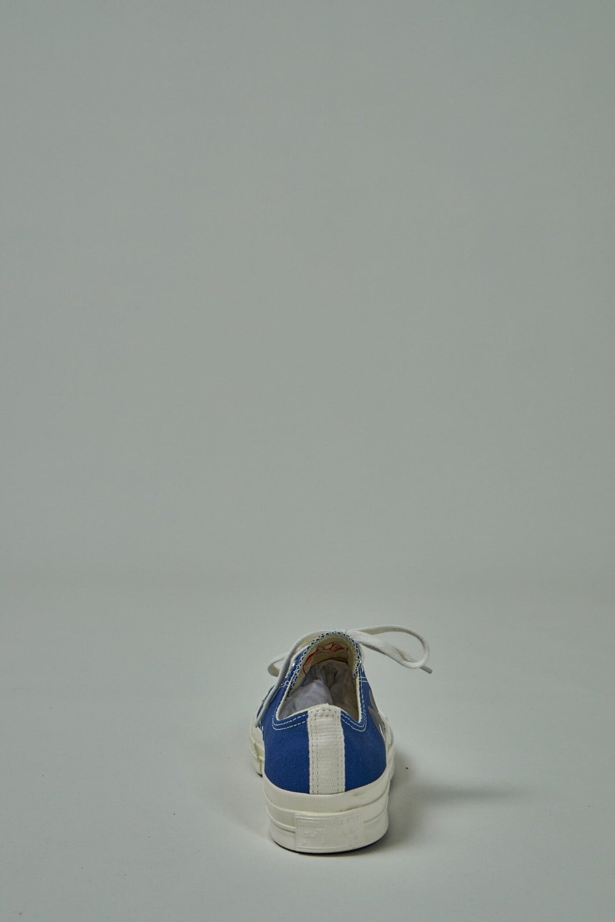 Front view of classic low-top Converse silhouette with CDG branding