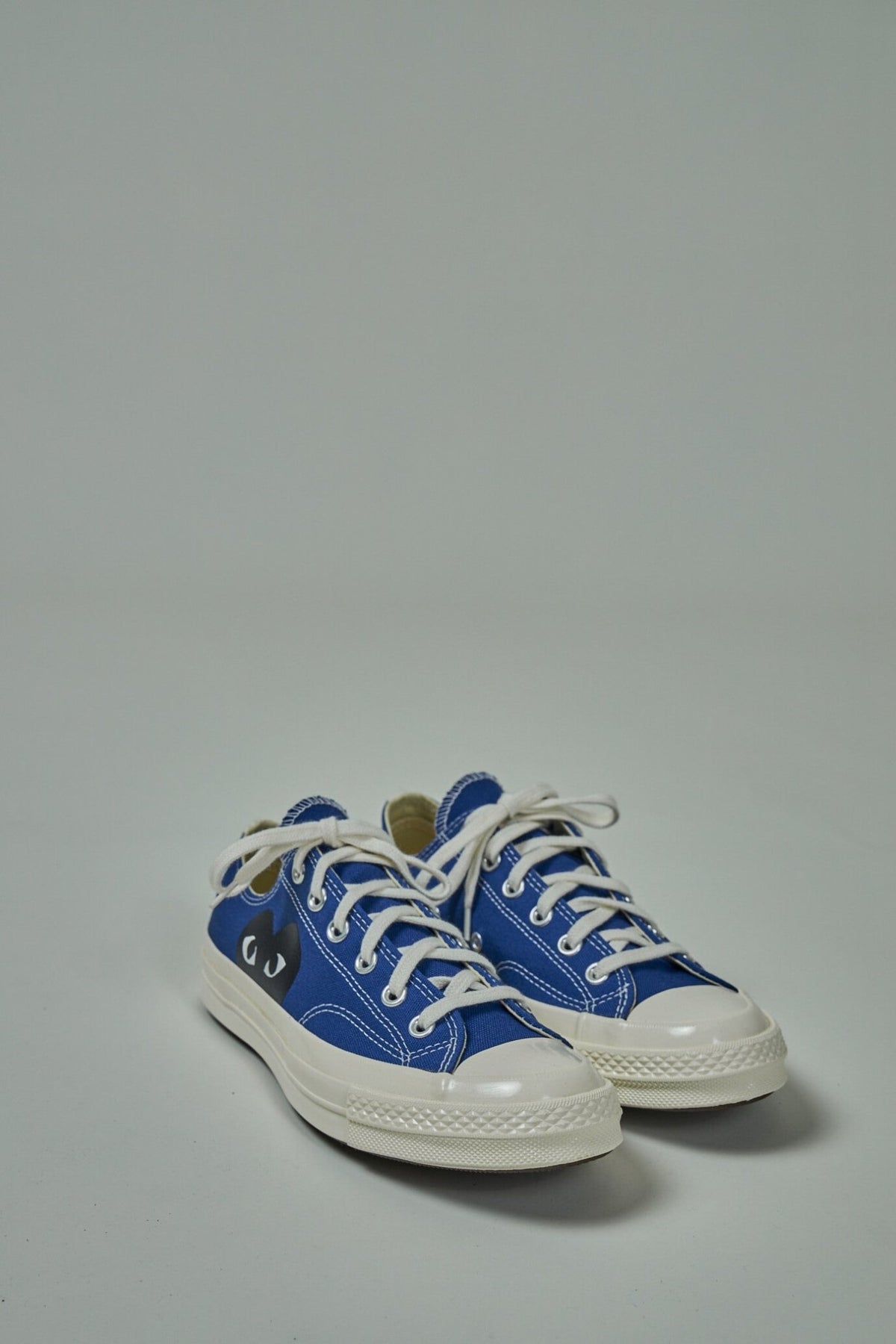 Side view of CDG PLAY Converse low sneakers showing fabric construction