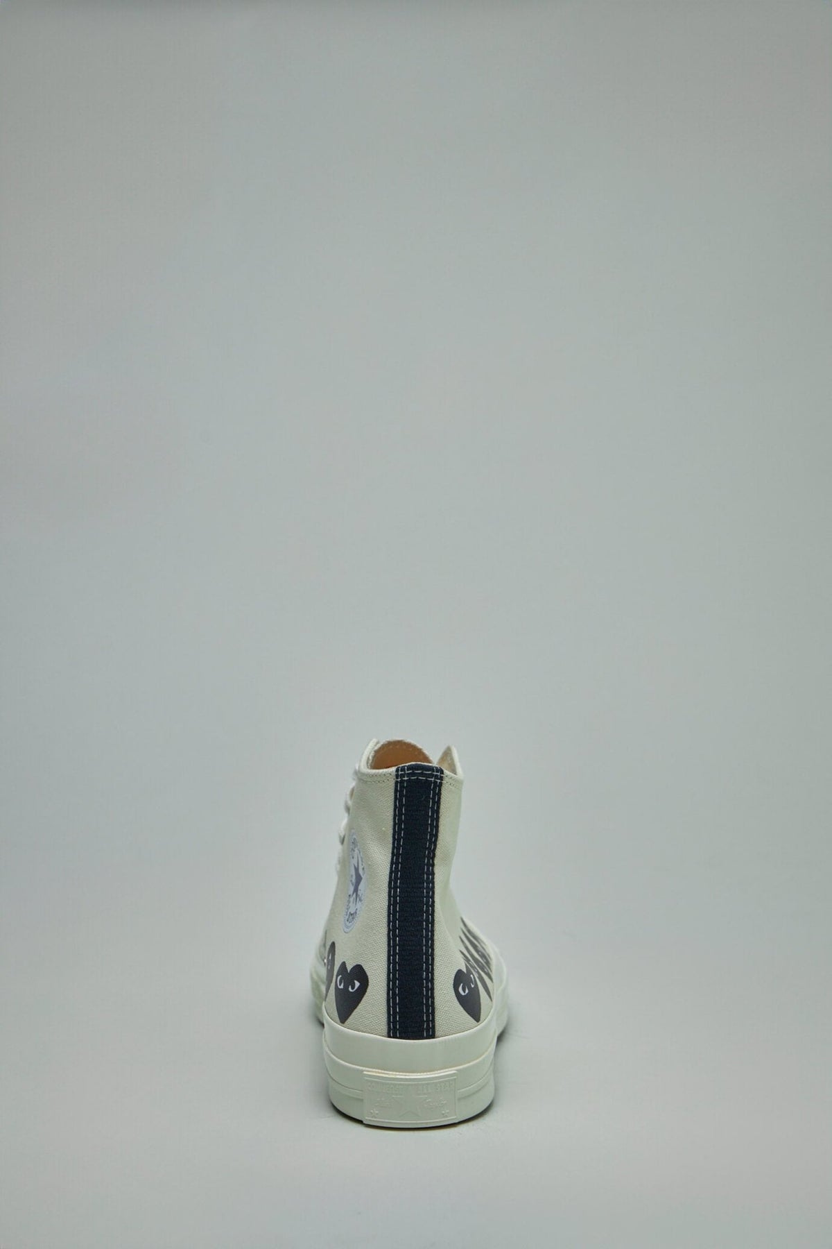 Back view of high top sneakers displaying heel design and branding