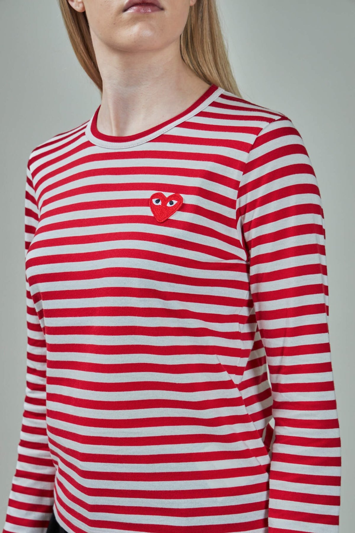 Model wearing CDG PLAY striped longsleeve t-shirt casual styling