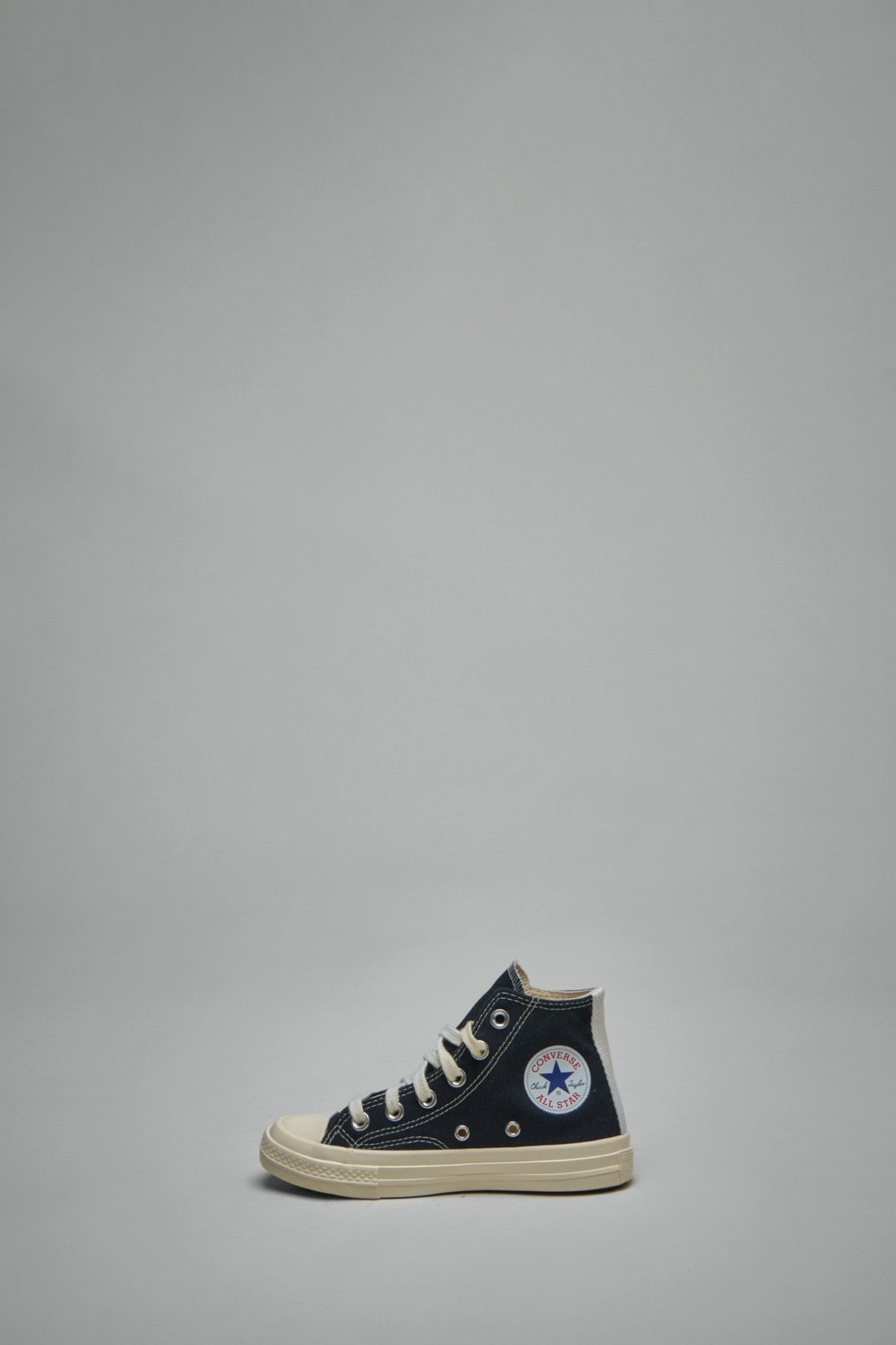 Kids wearing Comme des Garçons PLAY sneakers with casual outfit