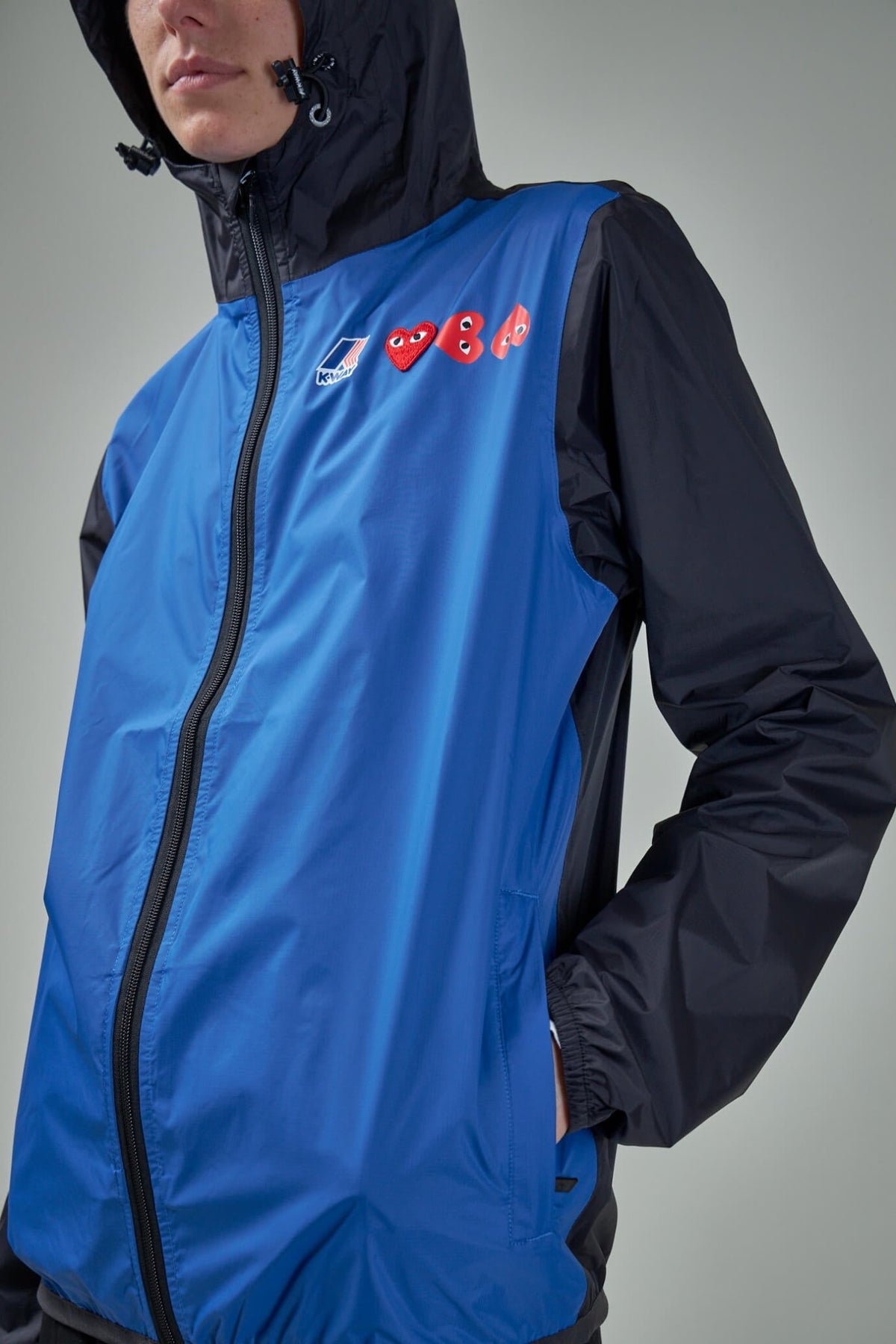 Back view of Comme des Garçons PLAY x K-Way raincoat showing silhouette and fit