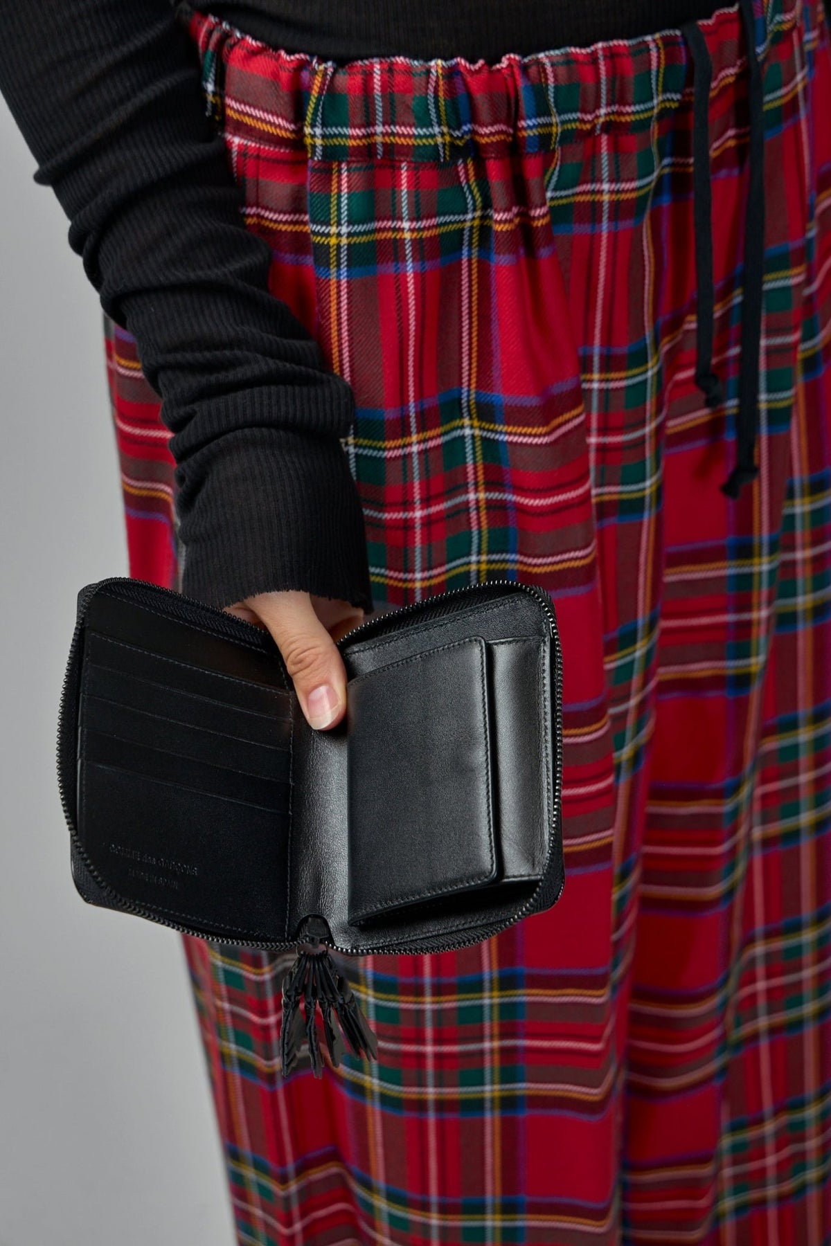 Glossy black leather finish detail on Comme des Garçons Zipper Medley wallet