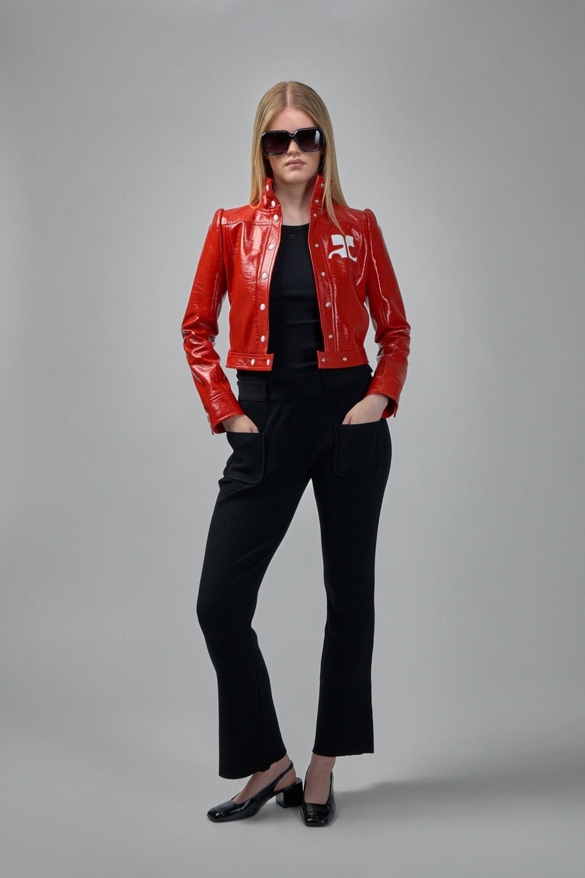 Close-up of ribbed knit texture and rectangular patch pockets on Courrèges pants