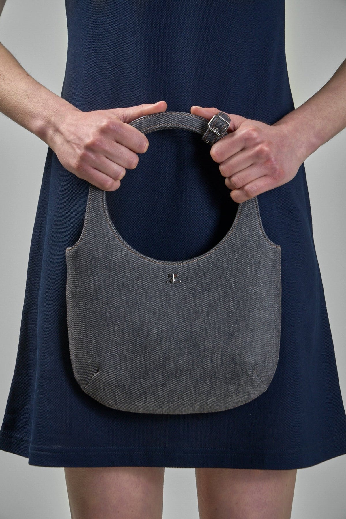 Styling shot of Courrèges Bag Holy Denim worn with contemporary fashion pieces