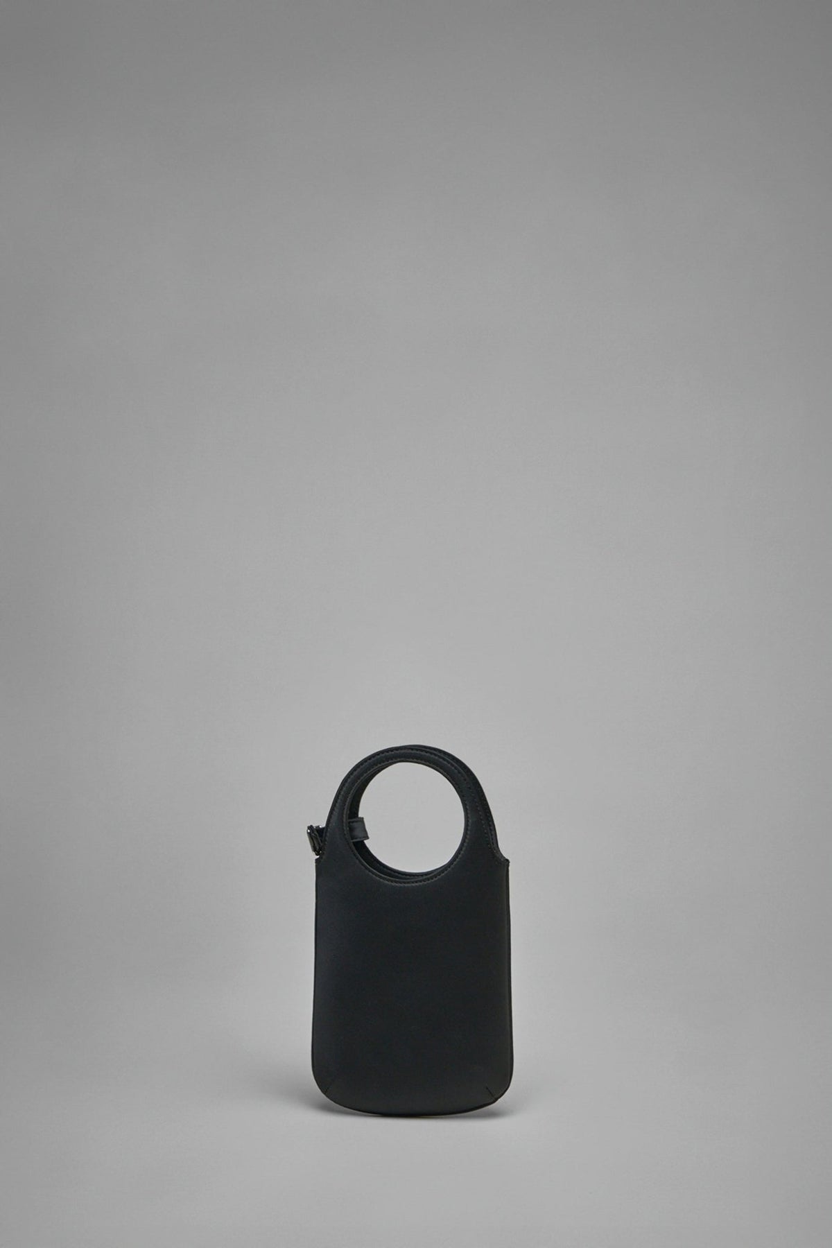 Close-up view of Courrèges Slim Holy Satin bag showing magnetic closure detail