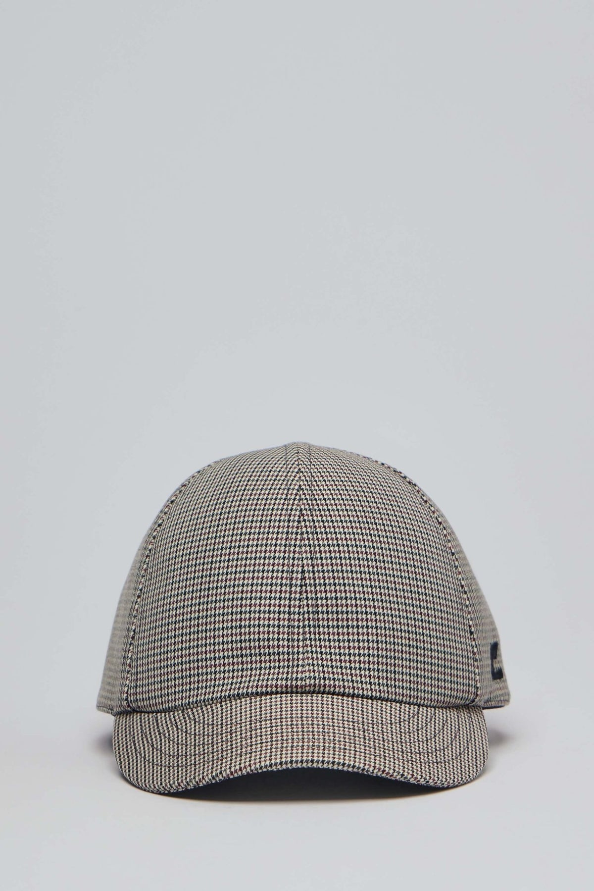 Courrèges caps in classic black and white houndstooth pattern with curved visor