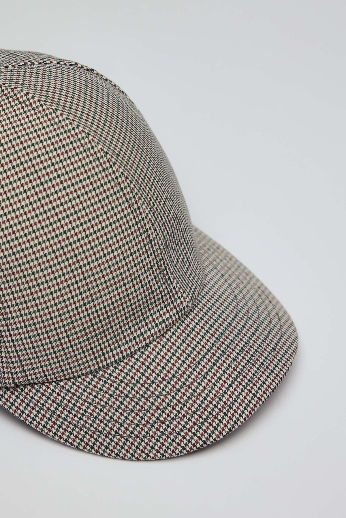 Close-up view of houndstooth pattern detail on Courrèges baseball cap