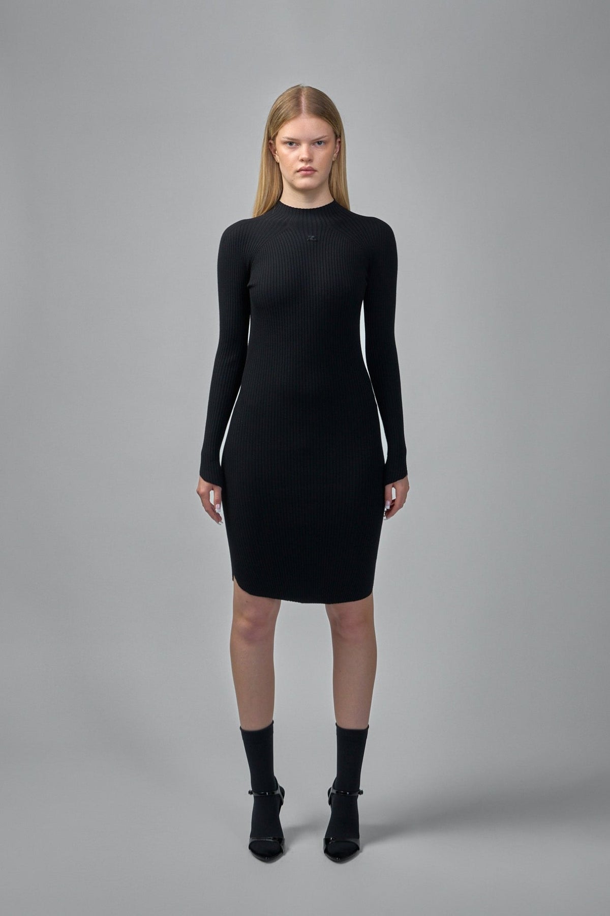 Close-up of ribbed knit texture and Courrèges logo detail on midi dress
