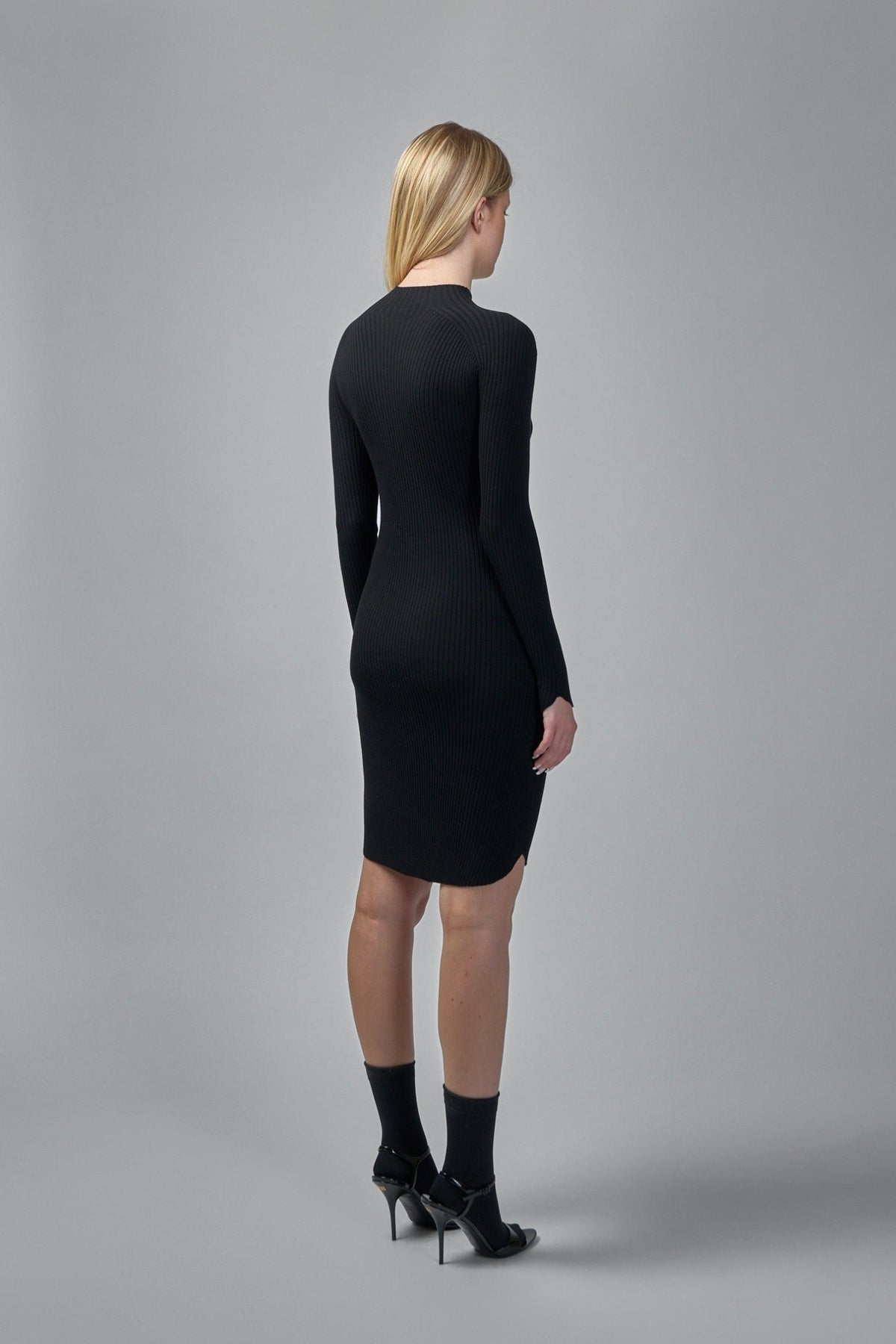Full-length view of bodycon midi dress showing knee-length hemline