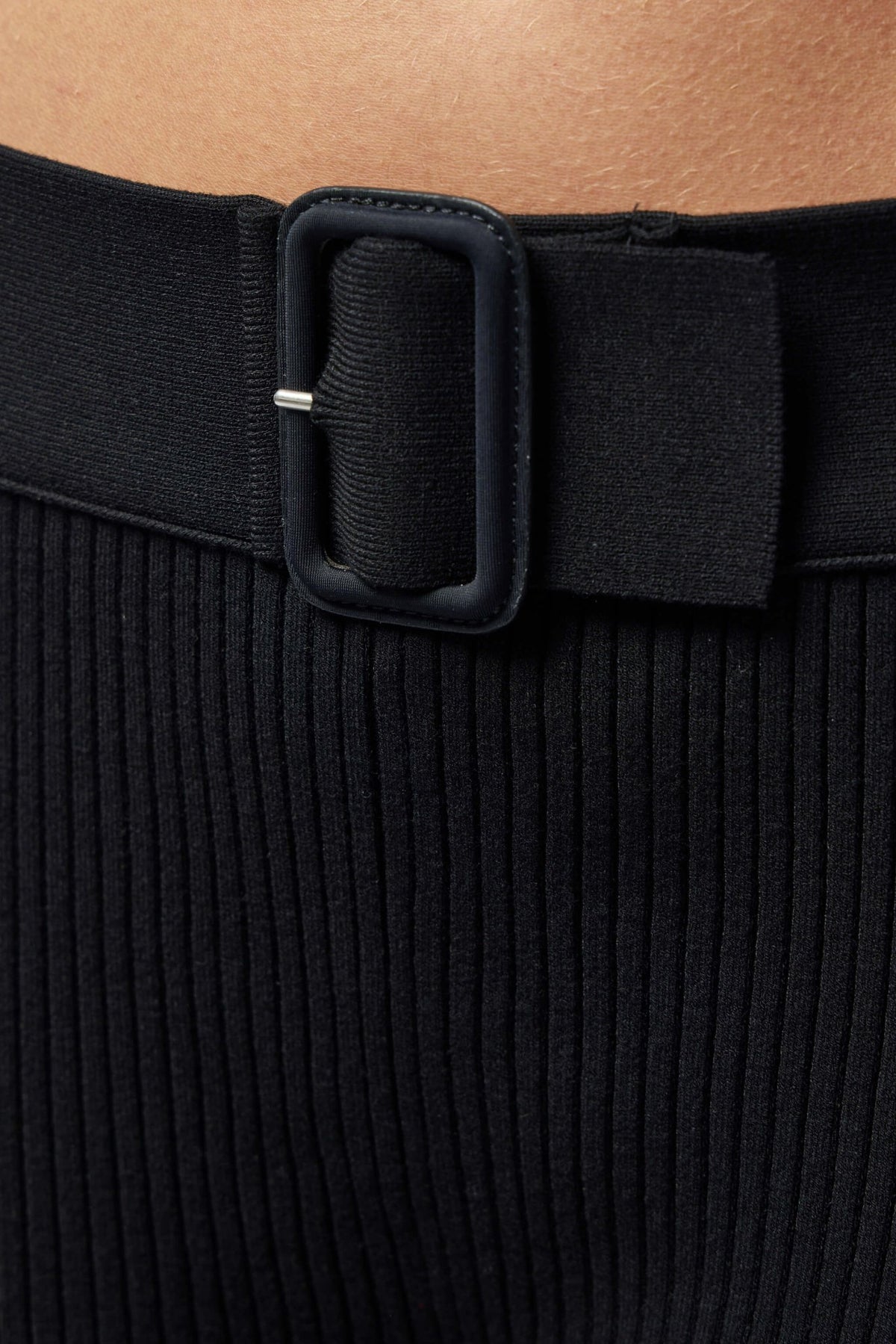 Model wearing Courrèges ribbed flared pants with fitted top