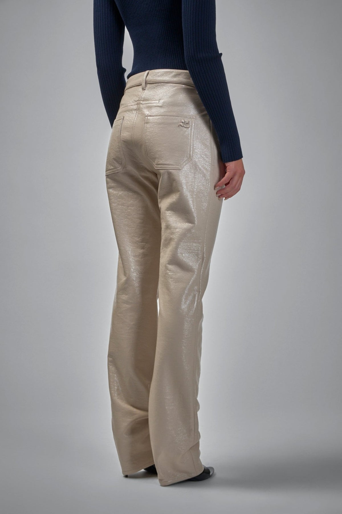 Model wearing Courrèges Reedition vinyl pants with contemporary styling