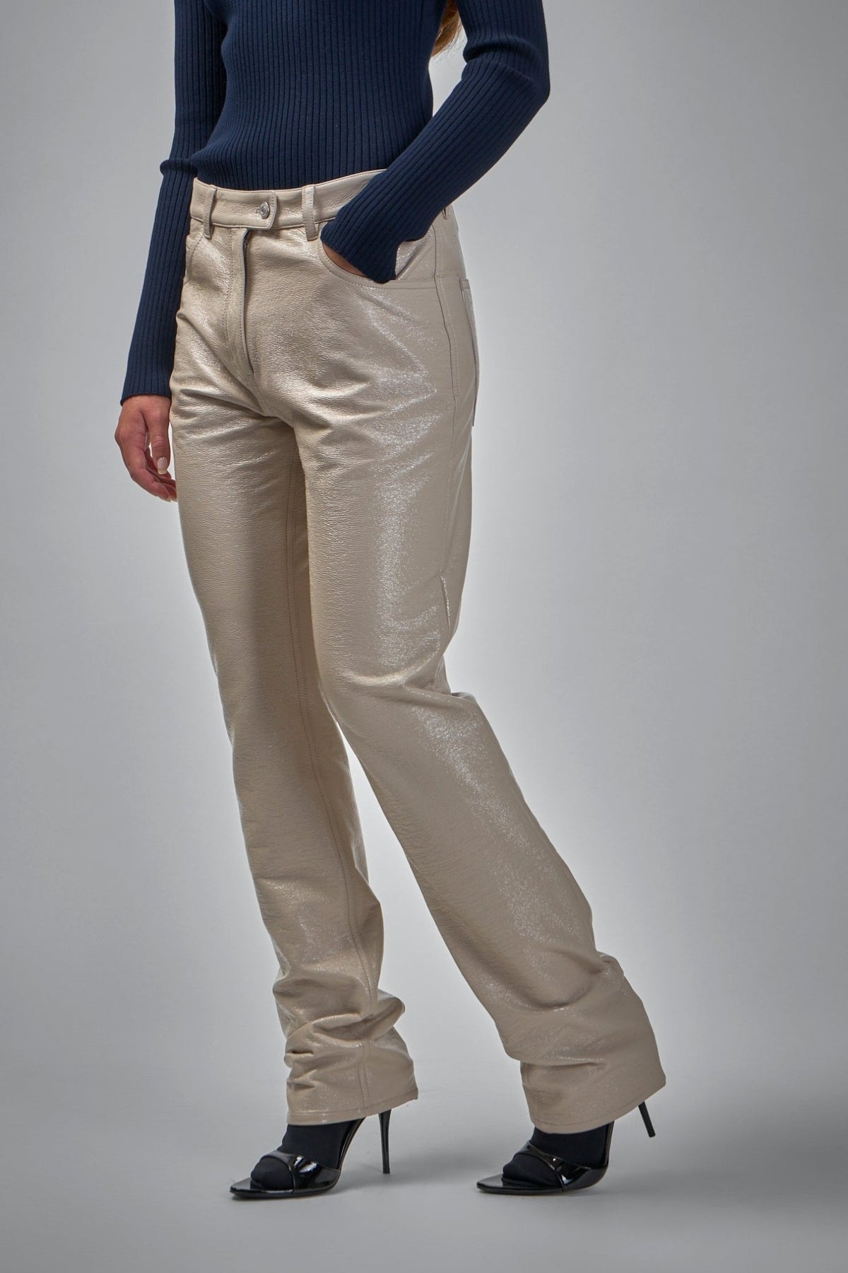 Back view of Courrèges straight-leg vinyl pants highlighting fit and silhouette
