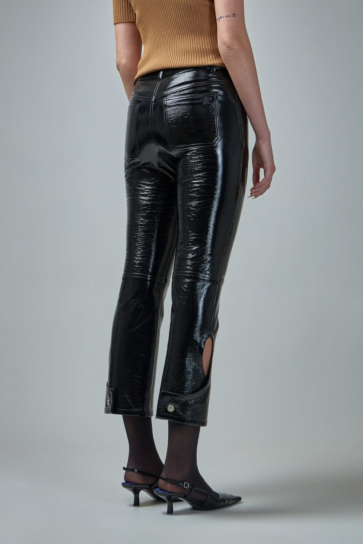 Side view showing cropped length and flex button closure at calf