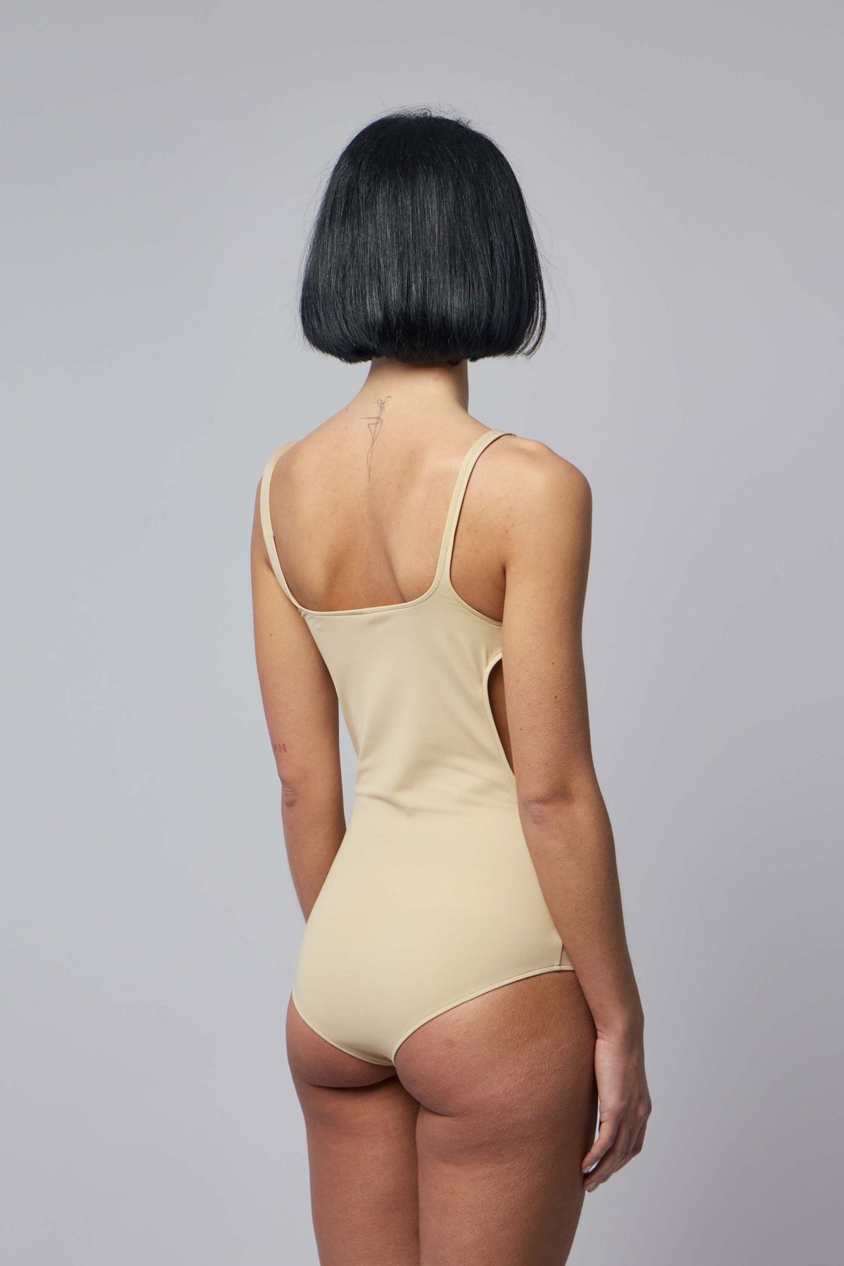 Back view of Courrèges buckle swimsuit highlighting adjustable strap design
