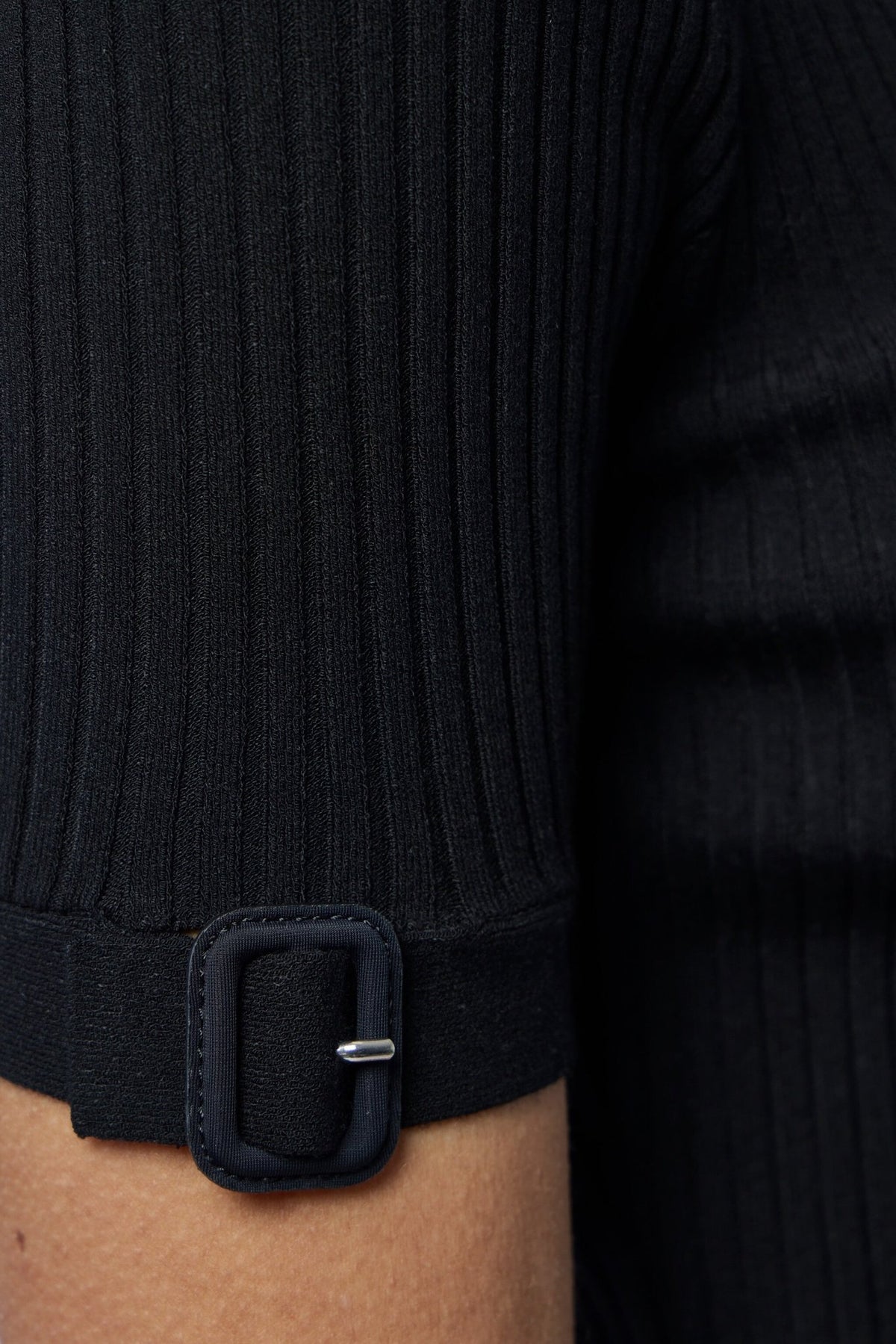 Styling shot of Courrèges buckle detail top with high-waisted bottoms