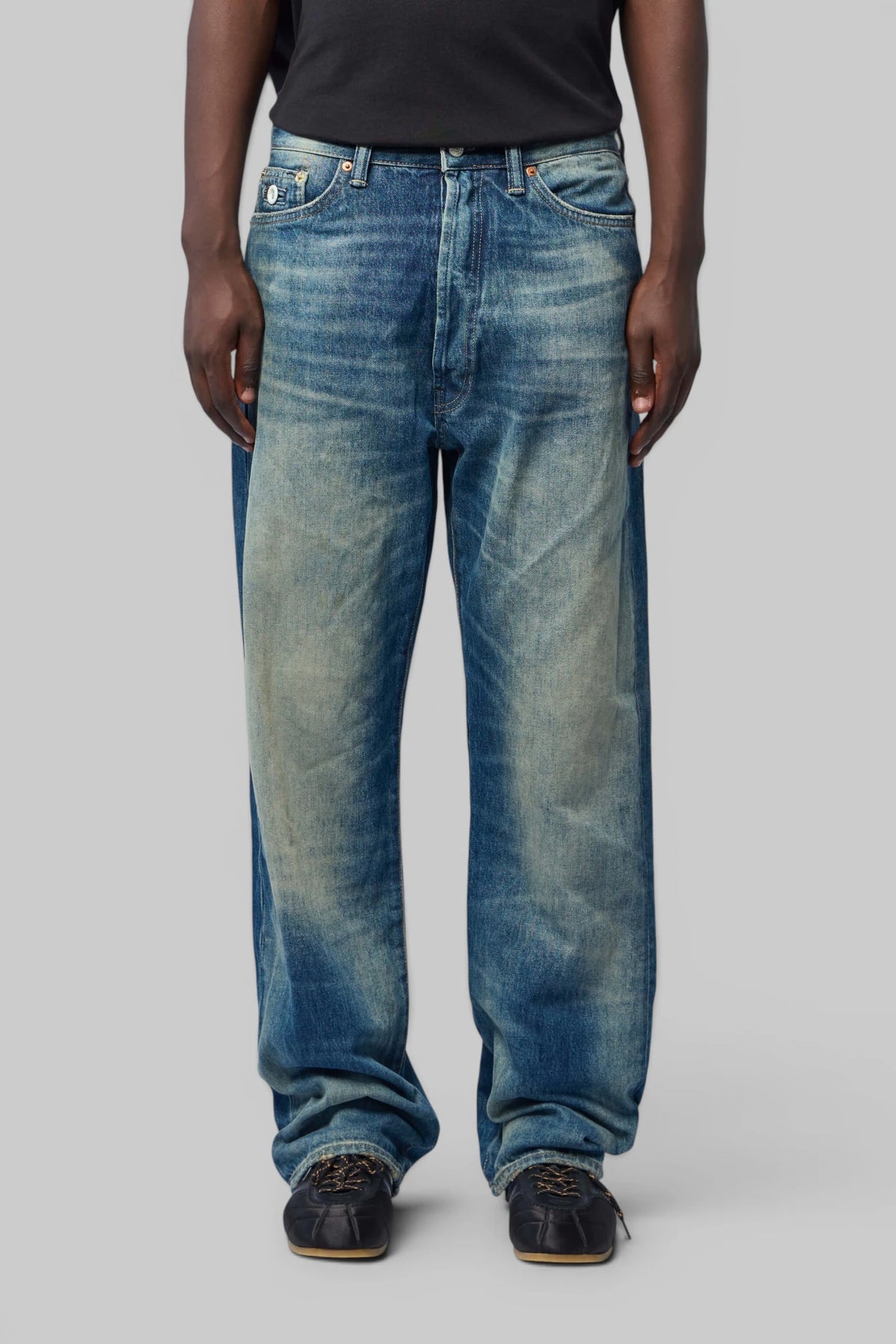 Close-up of leather brand patch on Denham Wide-Leg Jeans