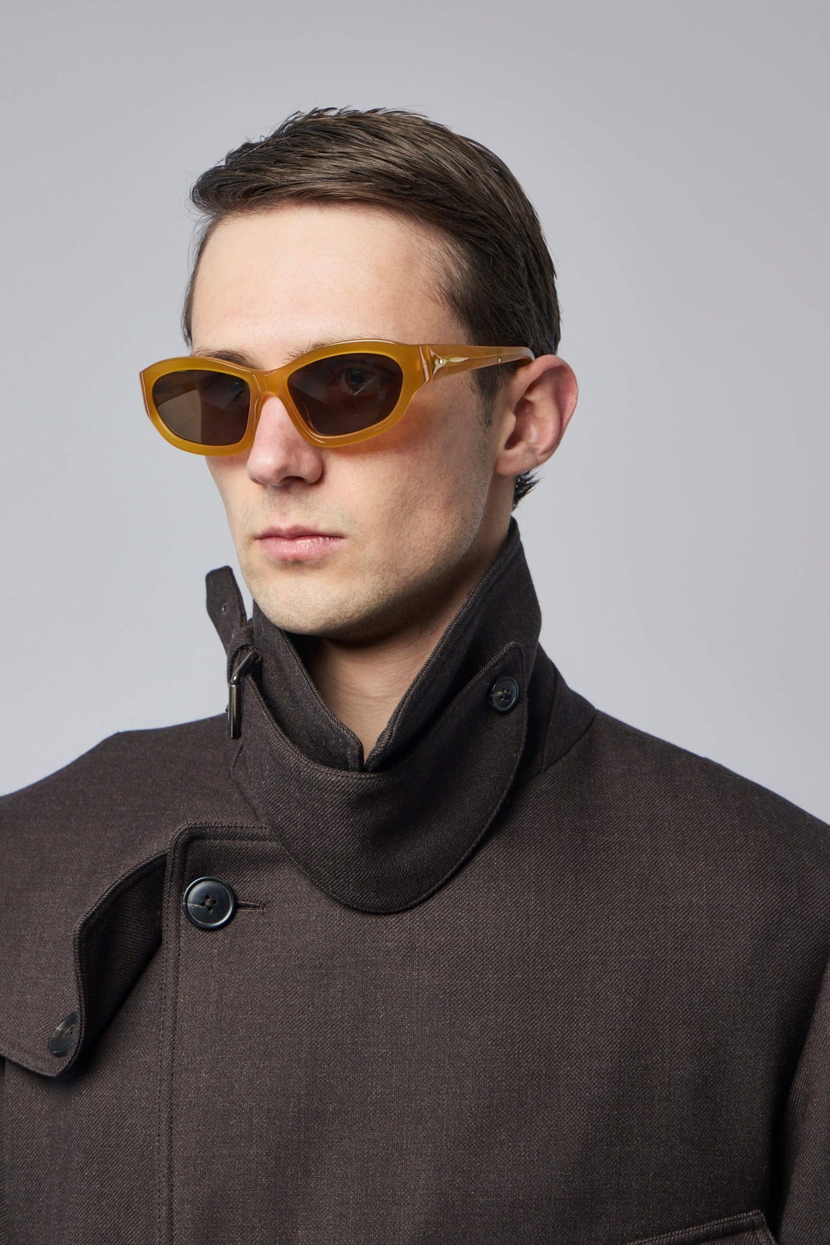 Close-up view of yellow acetate sunglasses frame detail