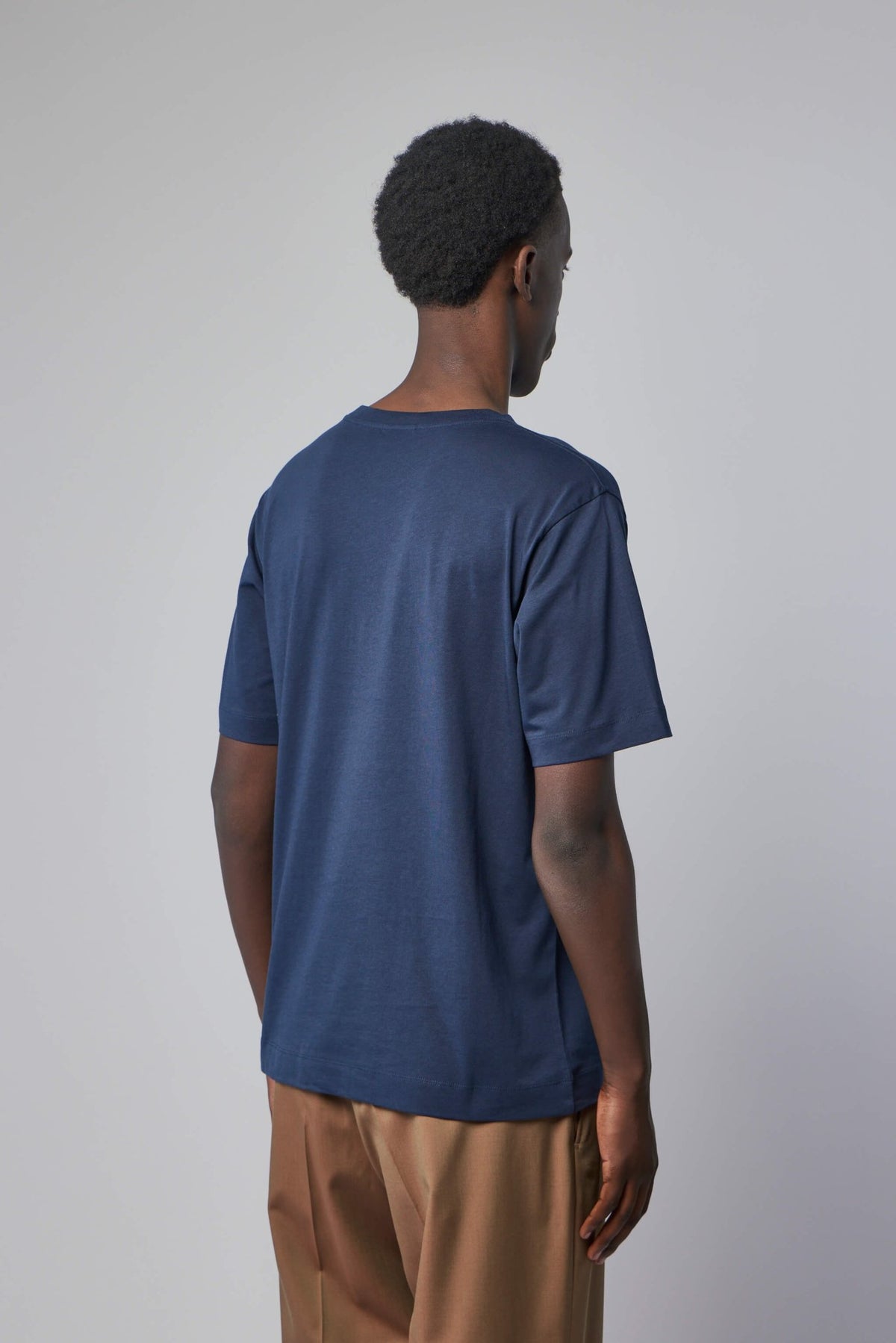 Flat lay styling of t-shirt with complementary pieces