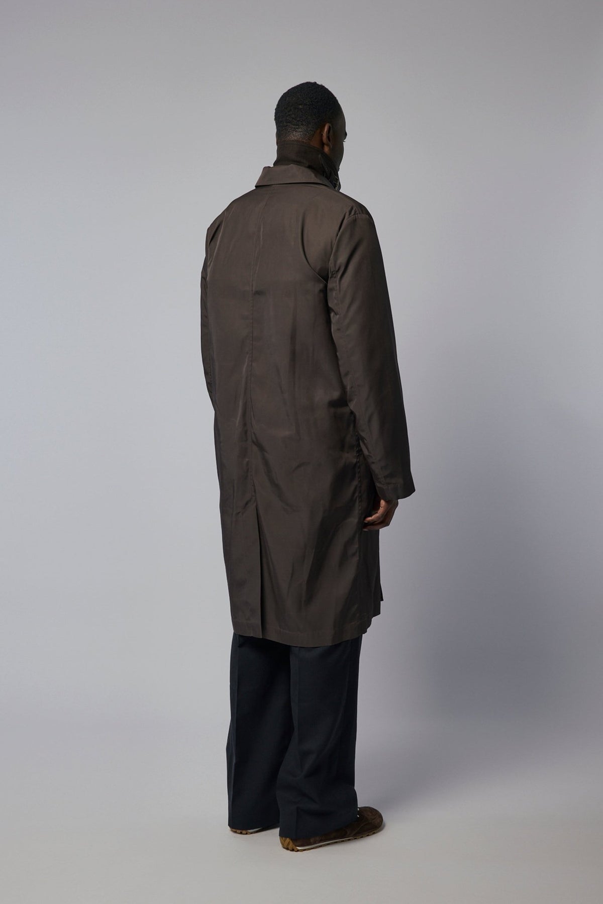 Side profile of brown wool coat by Dries Van Noten with straight cut silhouette