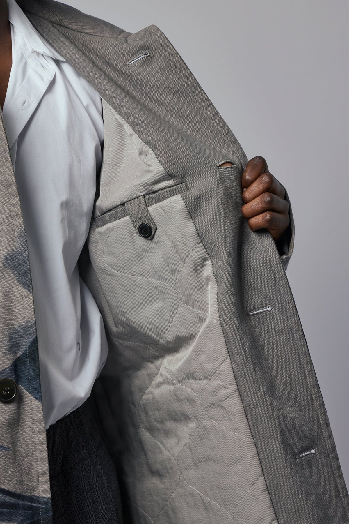 Button closure detail on Dries Van Noten M.W. Coat