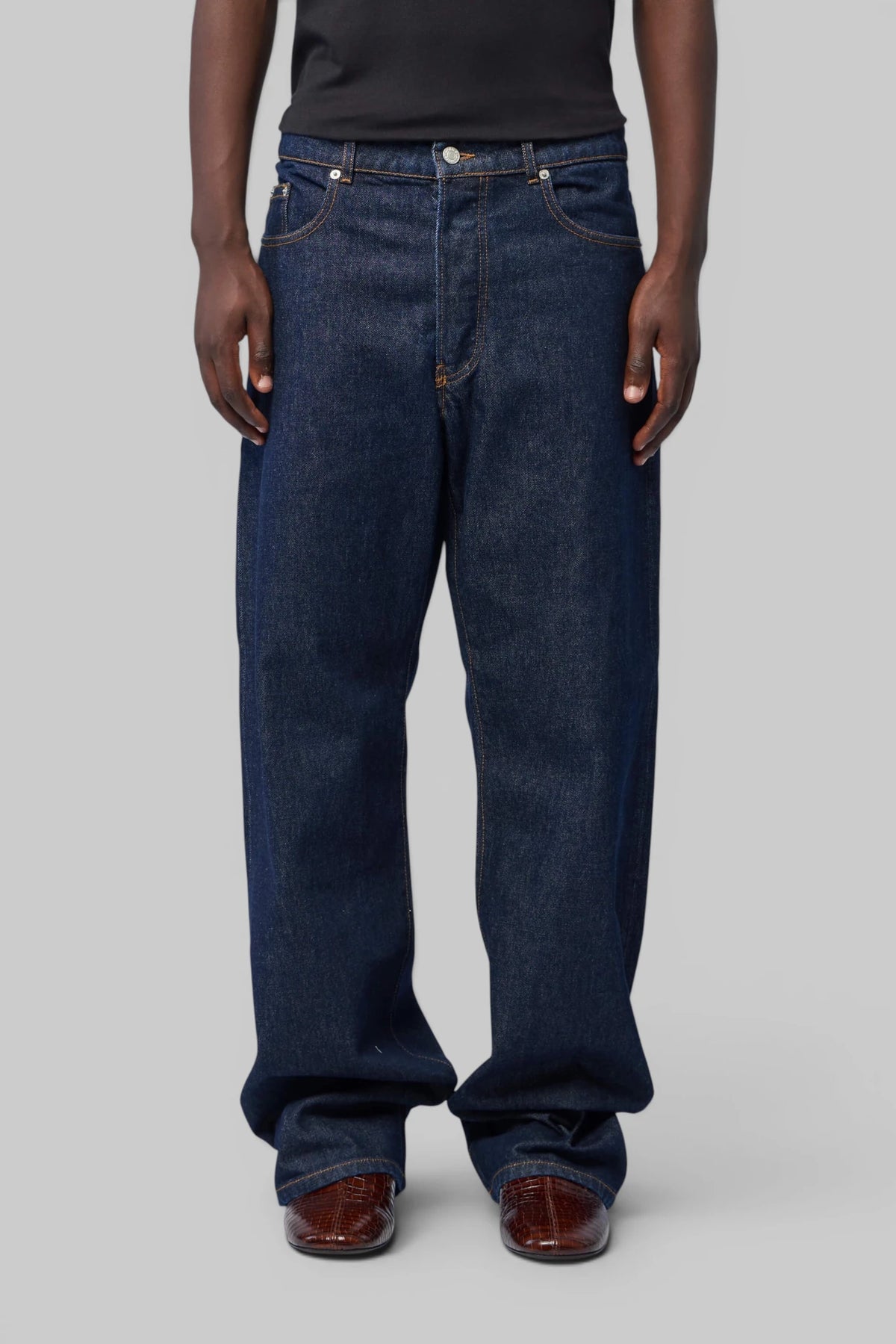 Close-up of copper rivet and contrasting topstitching on Dries Van Noten jeans