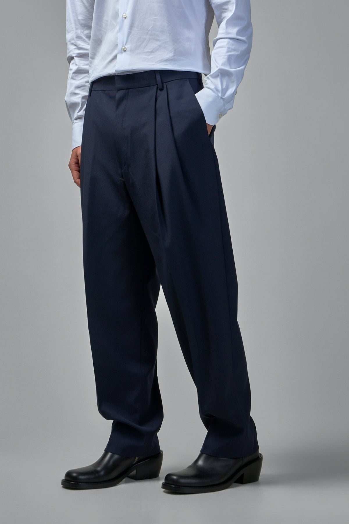 Detail of belt loops and side pockets on navy suiting fabric