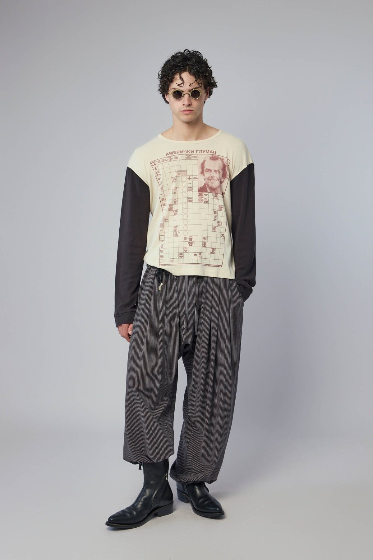 Flat lay presentation of cream and black designer long-sleeve tee