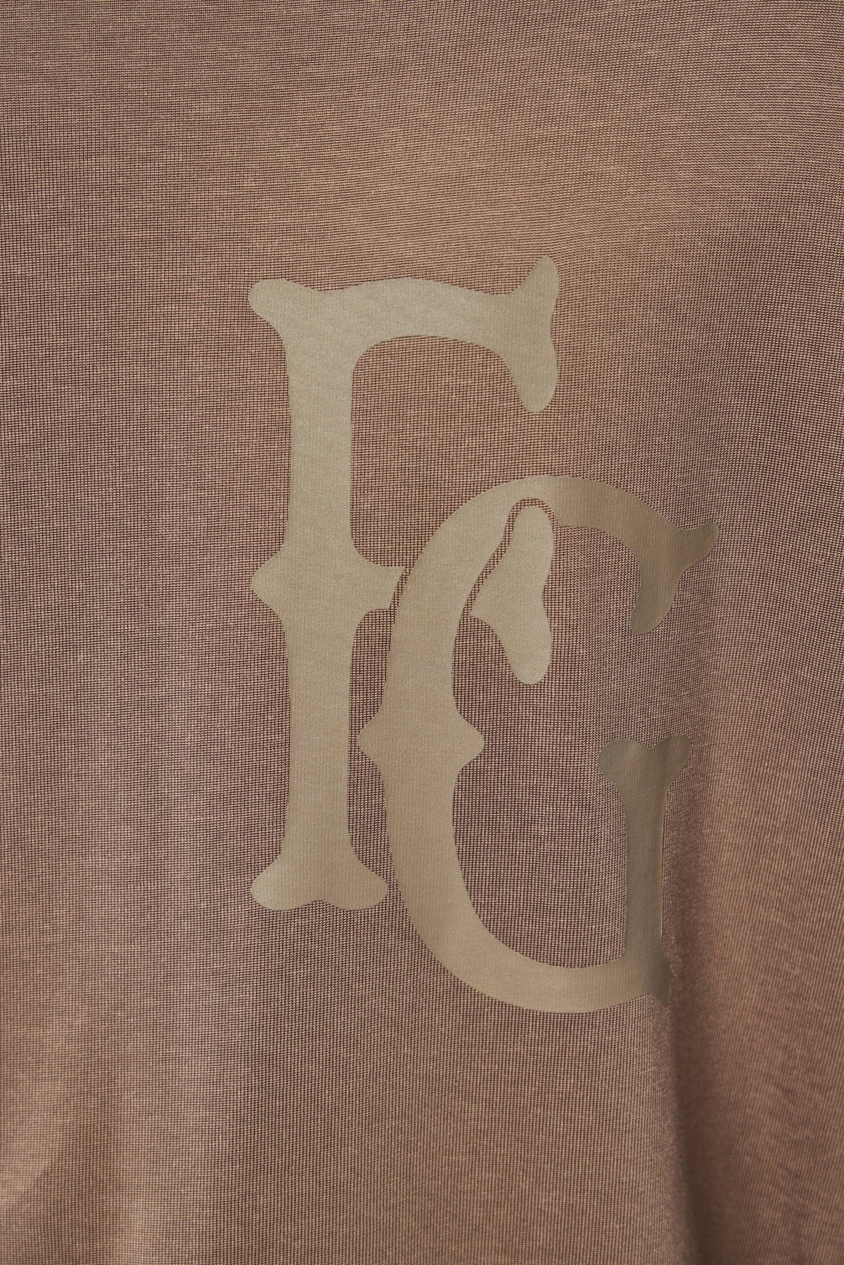 Detail shot of Fear Of God tee ribbed collar and signature branding elements