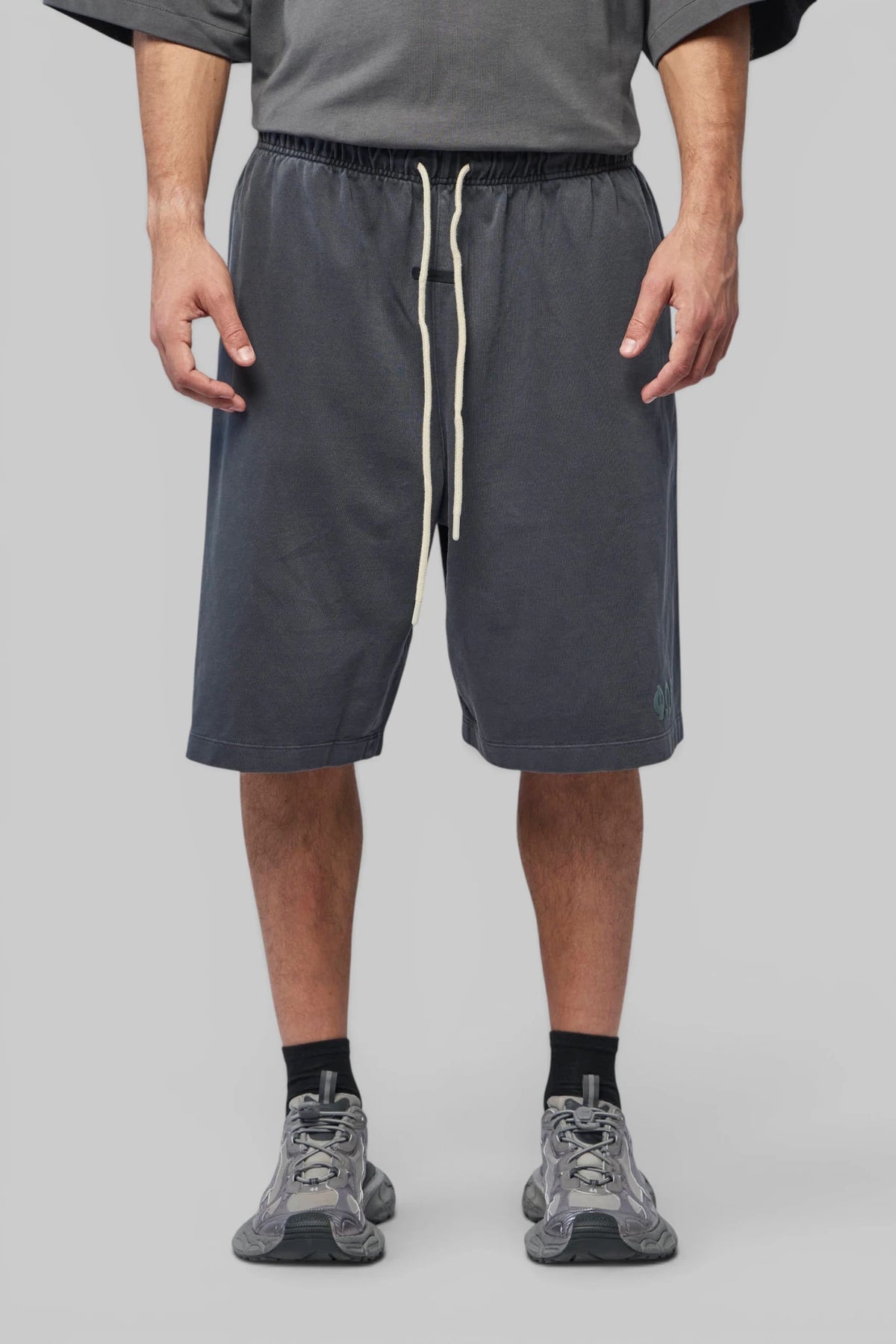 Side profile of Fear Of God Essentials Shorts highlighting pocket detail
