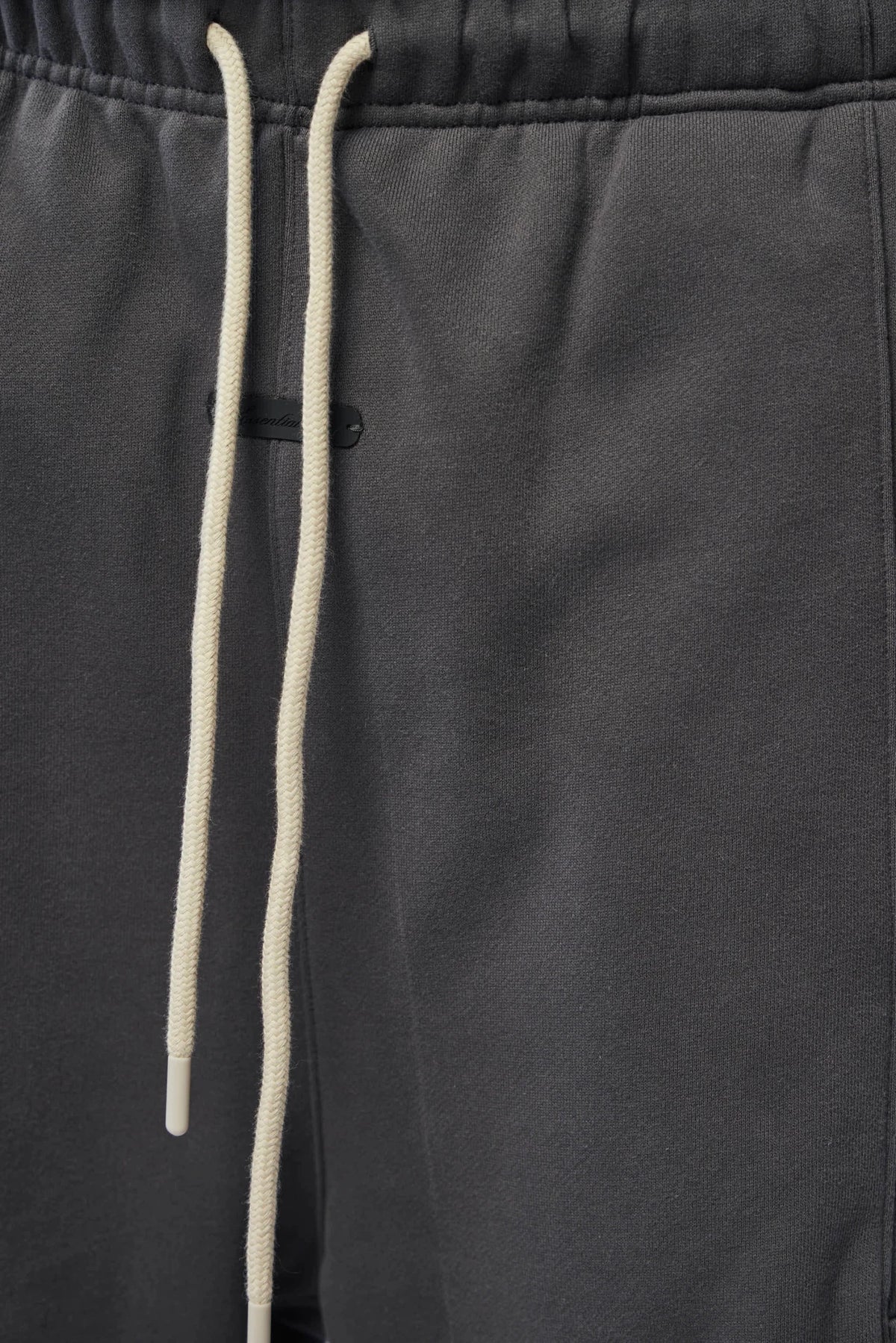 Back view of Fear Of God Essentials Cargo Pants in dark grey cotton blend