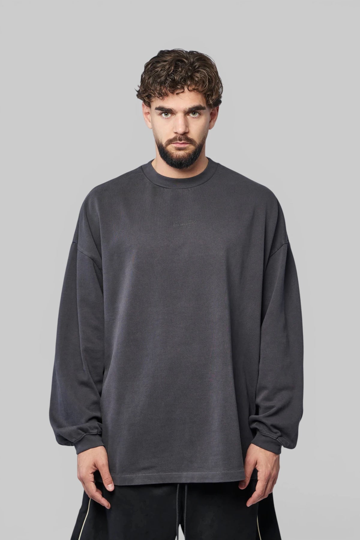Close-up of chest logo on Fear Of God Essentials Long Sleeve Tee
