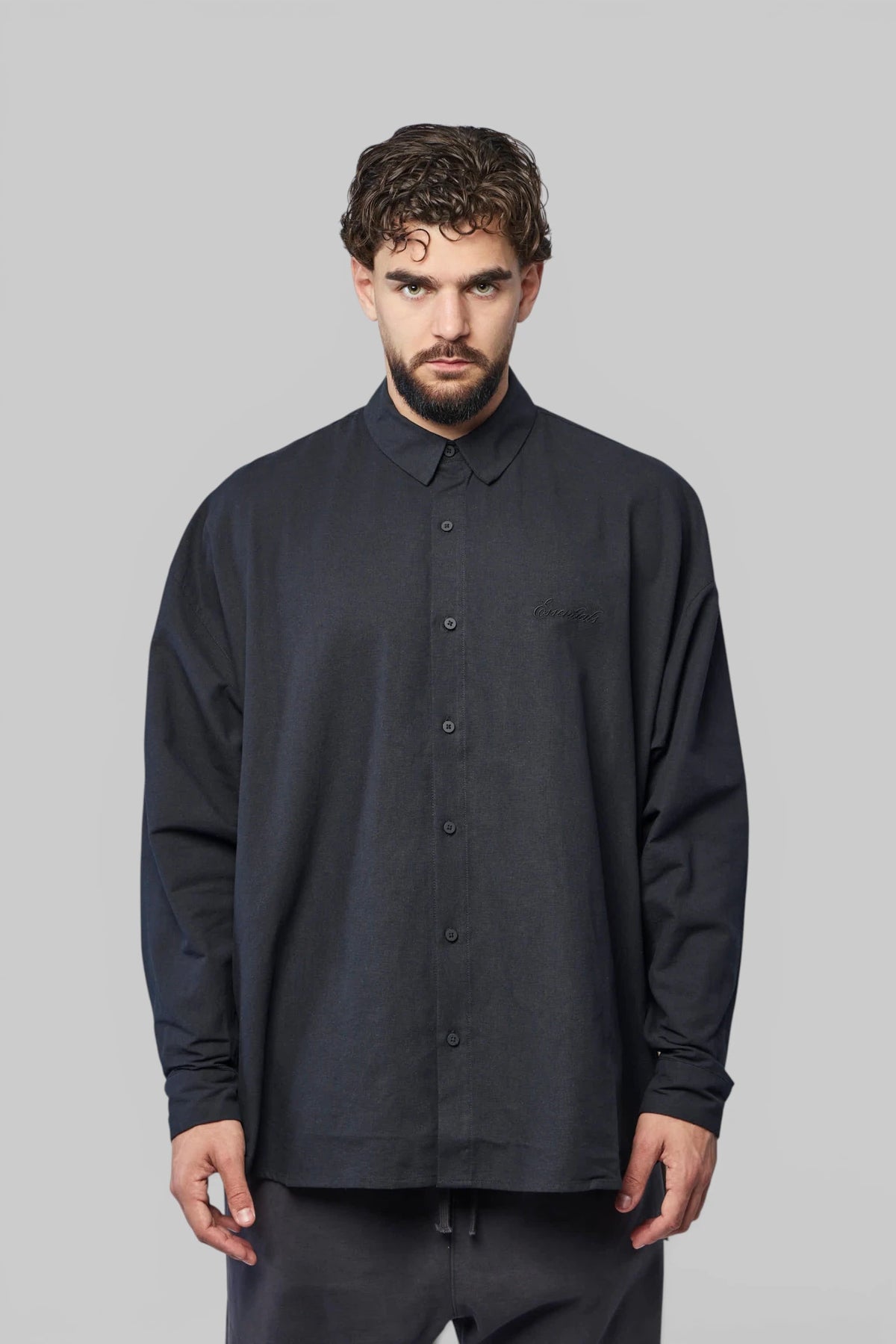 Close-up of embroidered logo on Fear Of God Essentials shirt