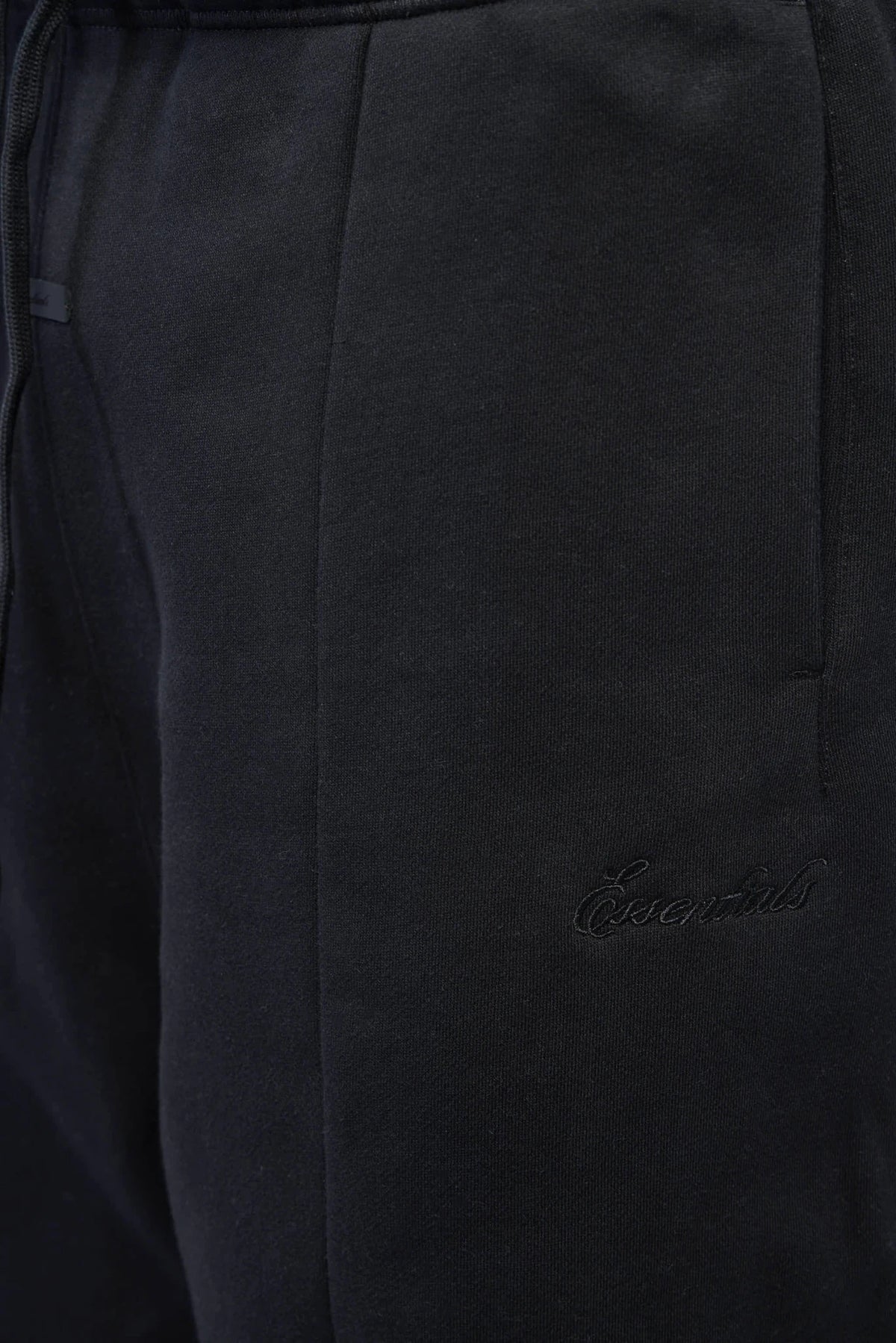 Model wearing Fear Of God Essentials Wide-Leg Pants styled casually